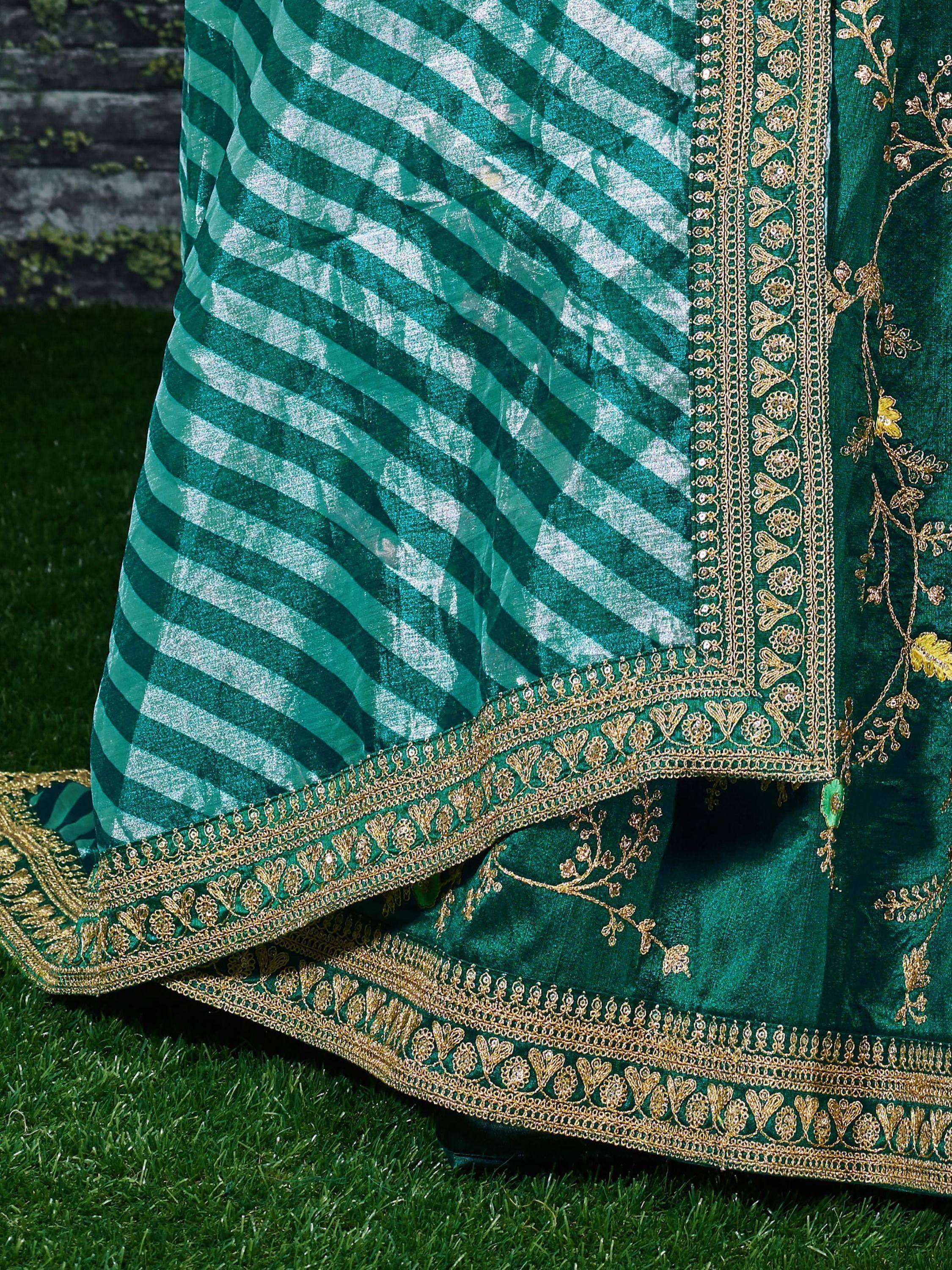 Emerald green ethnic lehenga with gold embroidery and striped dupatta, perfect for Indian weddings and festivals