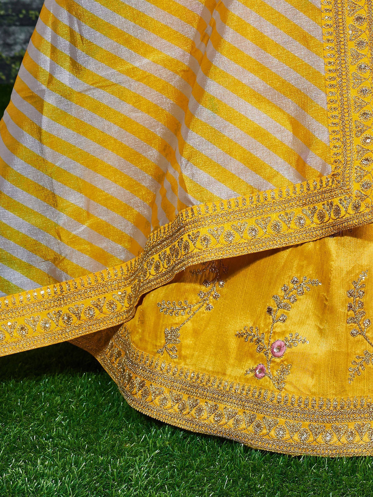 Yellow ethnic lehenga with gold embroidery and striped dupatta, perfect for Indian weddings and festivals