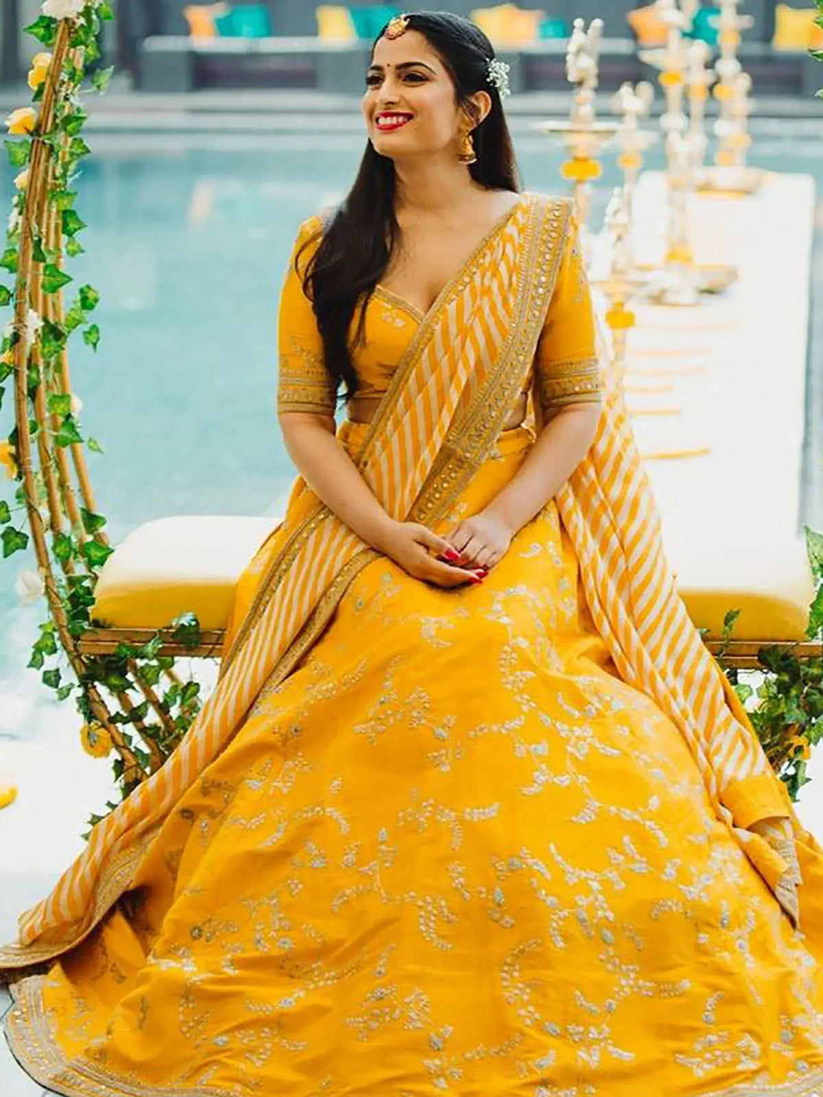 Yellow designer lehenga choli with gold embroidery, perfect for Indian weddings and festive occasions.