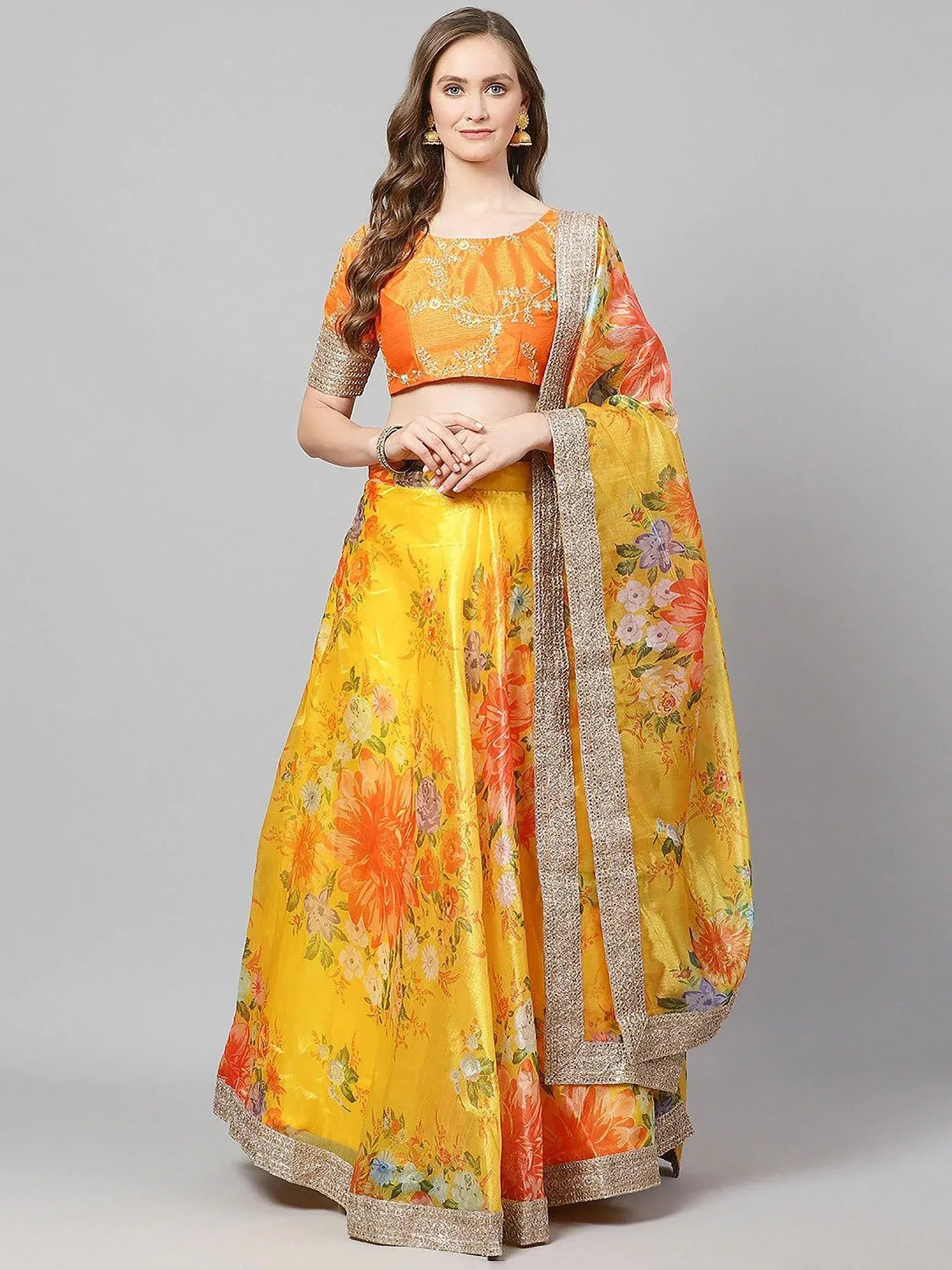 Vibrant yellow and orange floral lehenga choli with embroidered blouse and dupatta, perfect for Indian ethnic occasions.