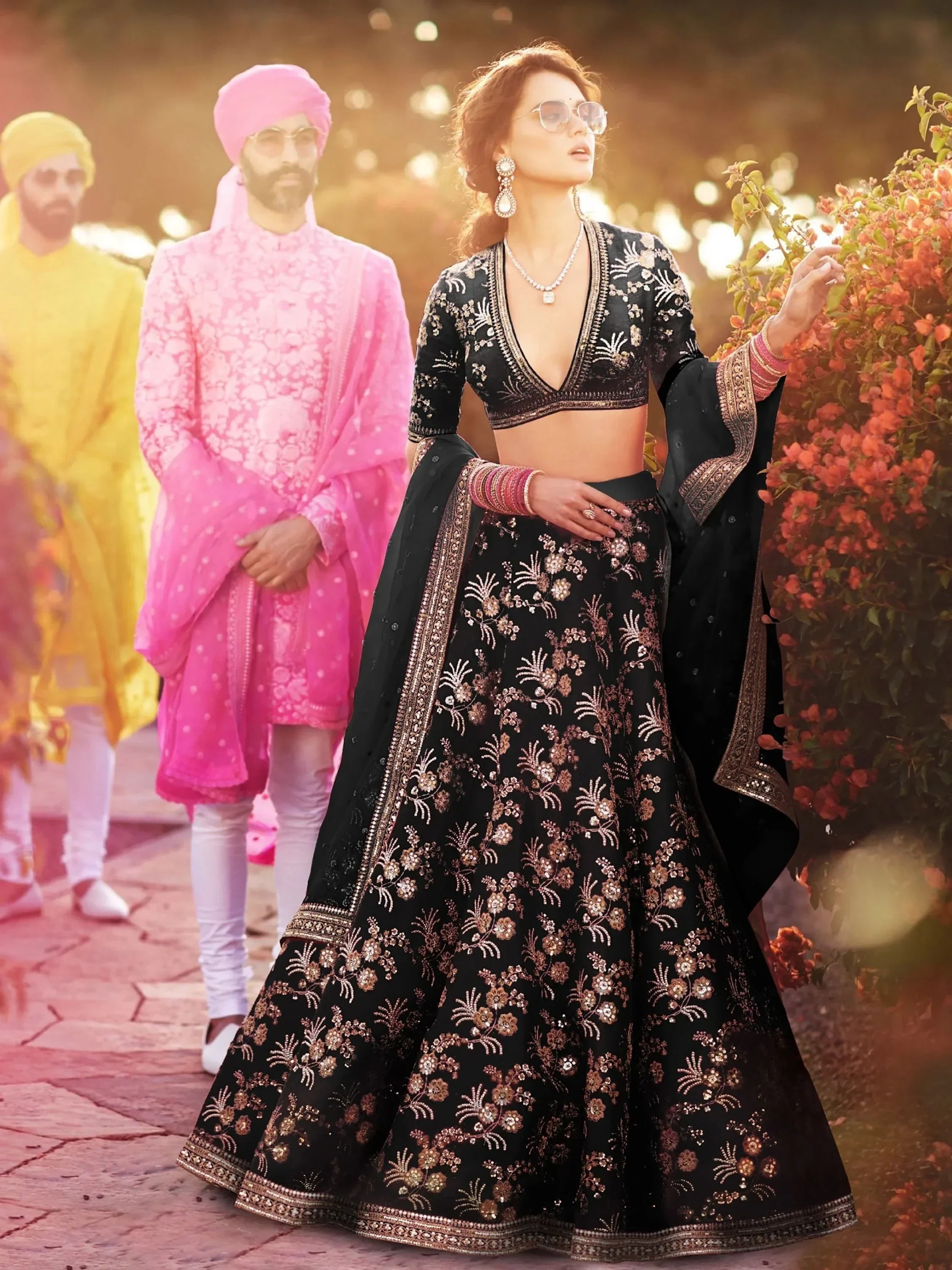 Black embroidered lehenga choli with gold floral work, perfect for Indian weddings and festive occasions.
