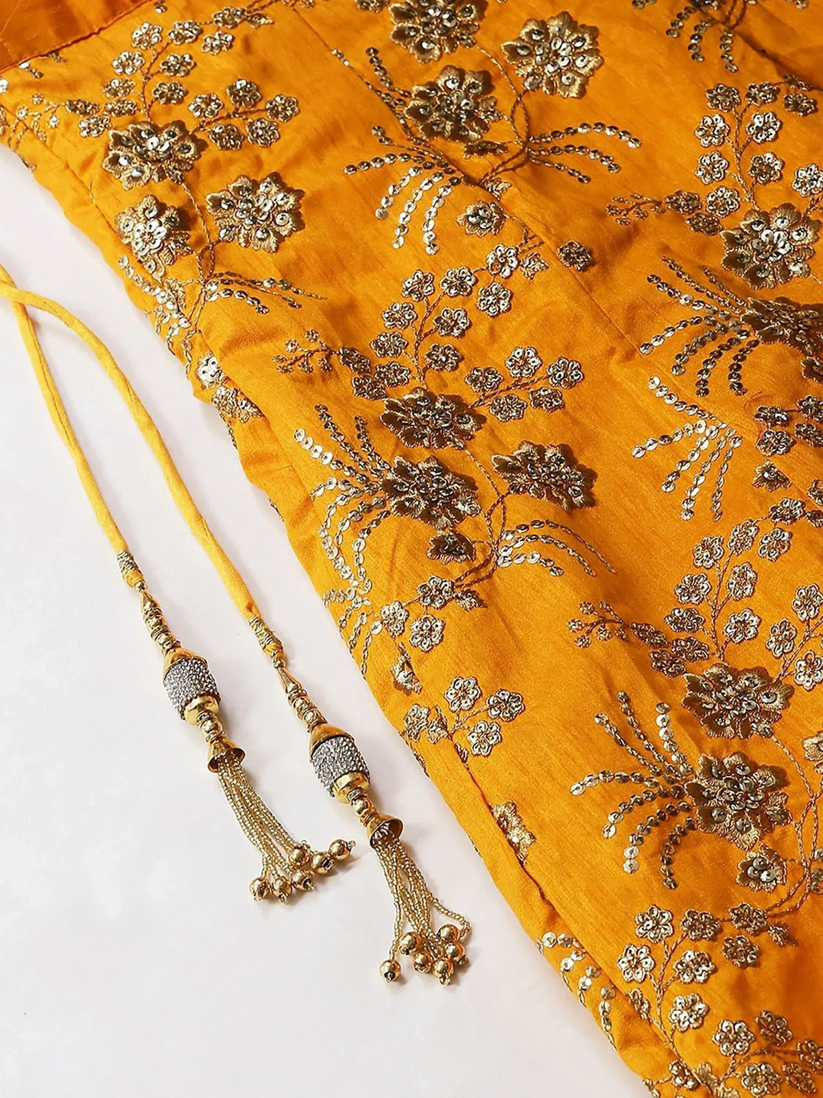 Mustard yellow ethnic top with gold floral embroidery and tassel detailing, perfect for Indian wear