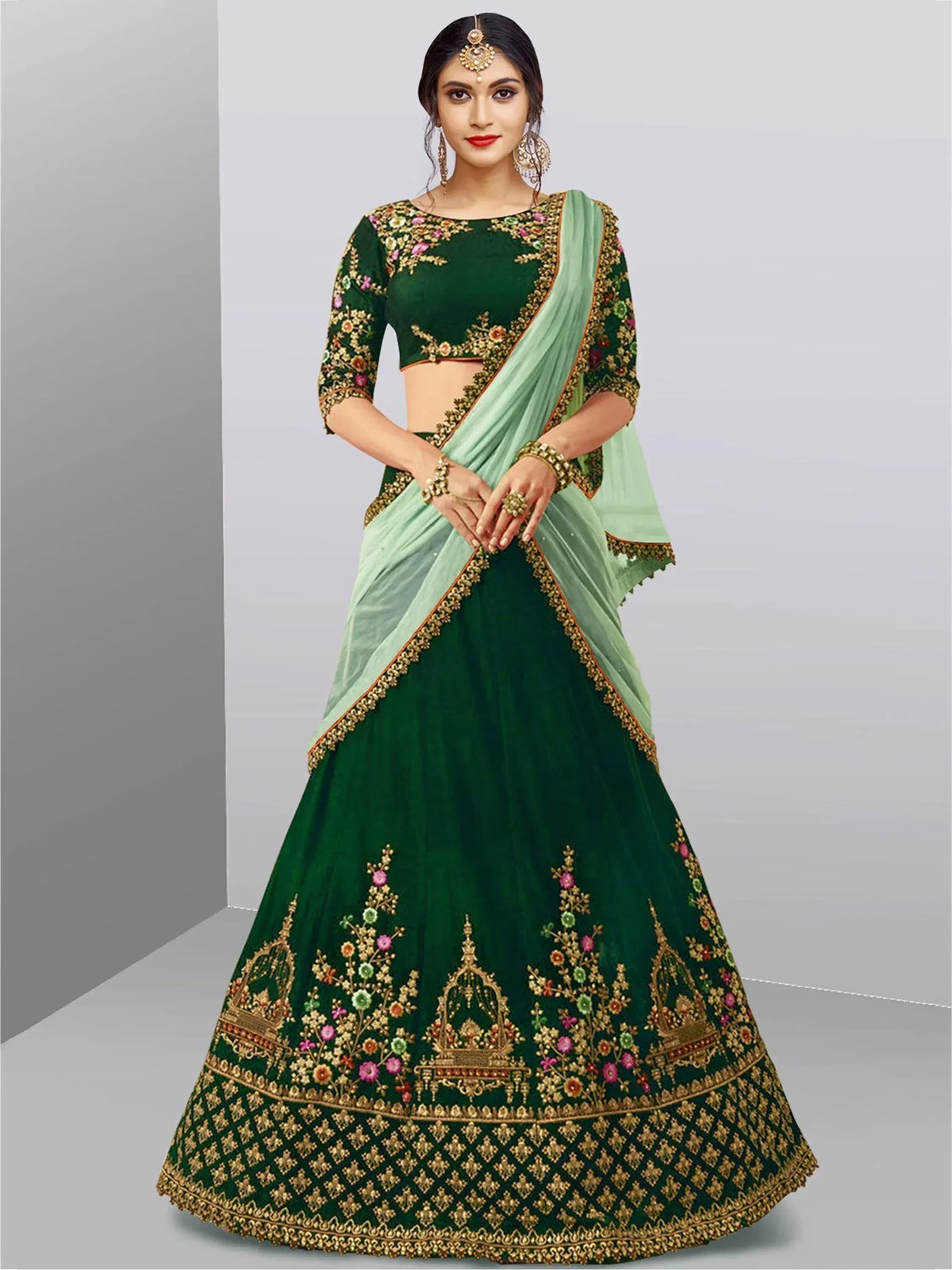 Emerald green designer lehenga choli with floral embroidery and light green dupatta, perfect for Indian weddings and festive occasions.
