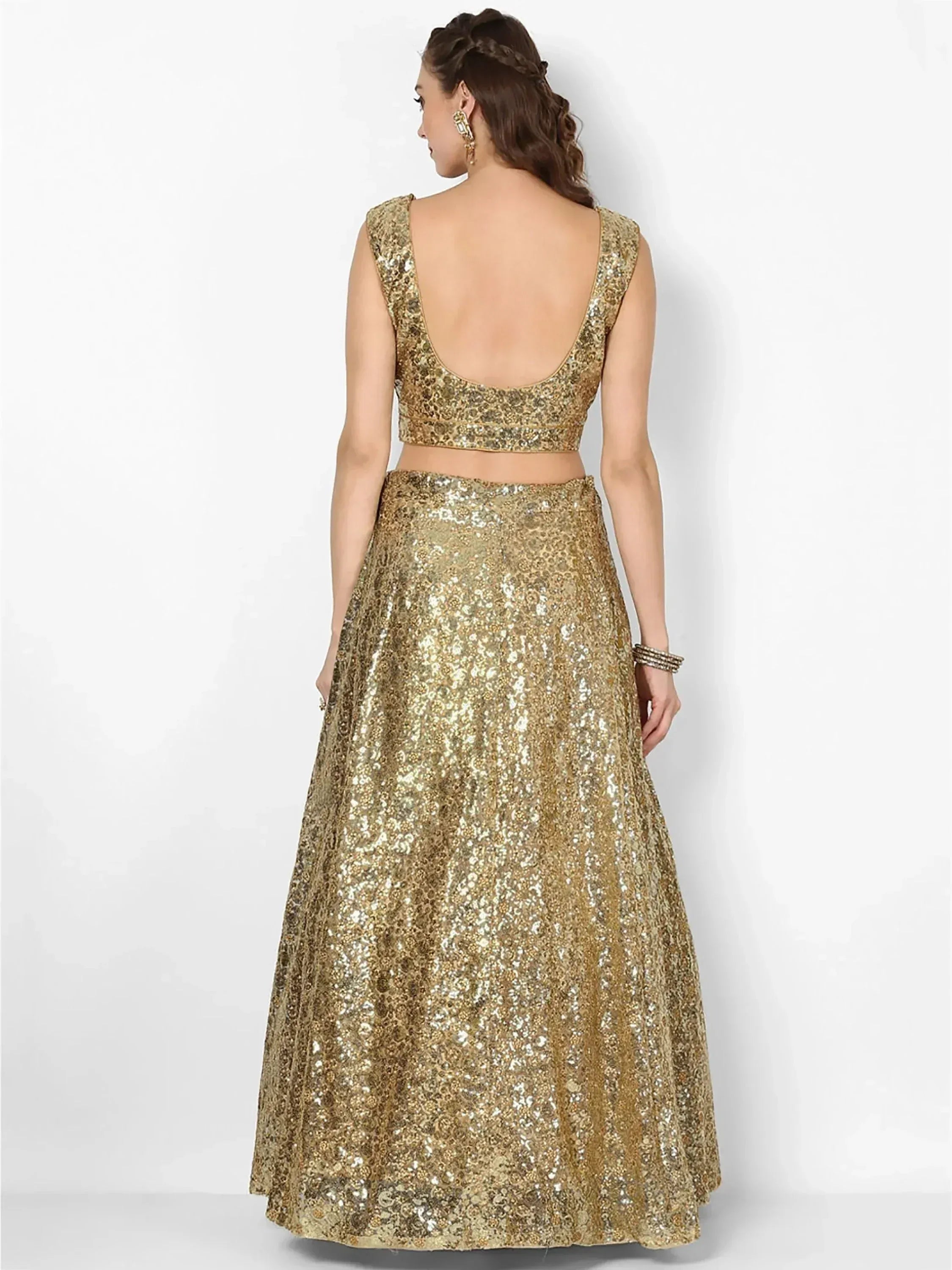 Gold sequin lehenga choli with backless blouse, perfect for Indian ethnic wear and festive occasions.