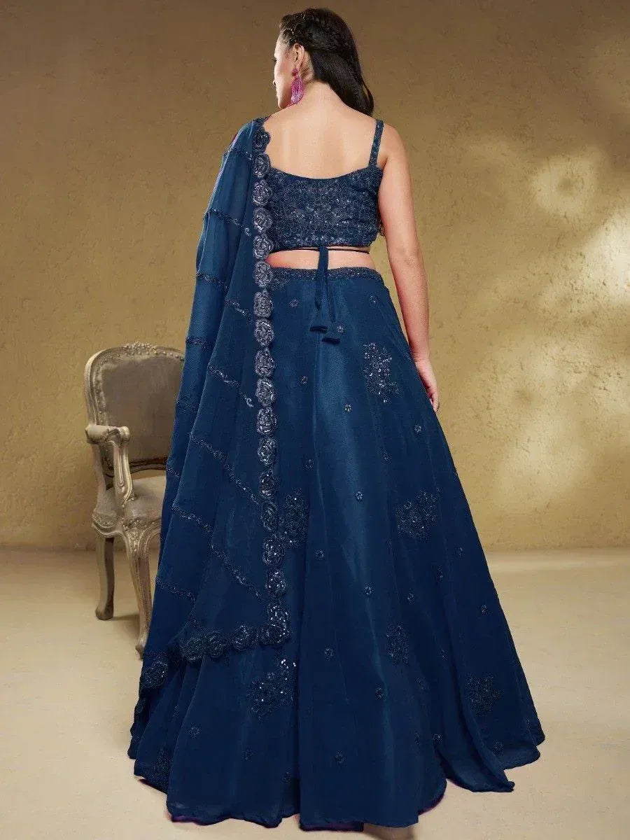 Navy blue designer lehenga choli with floral embroidery and sheer dupatta, perfect for Indian ethnic occasions.