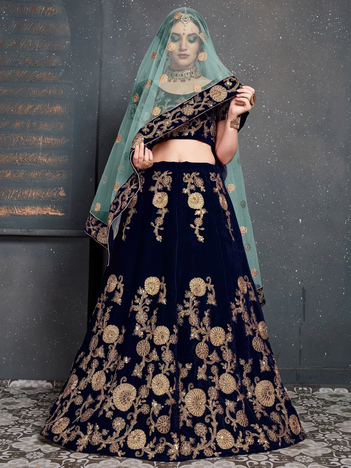 Navy blue velvet lehenga choli with gold floral embroidery and mint green dupatta, perfect for Indian weddings