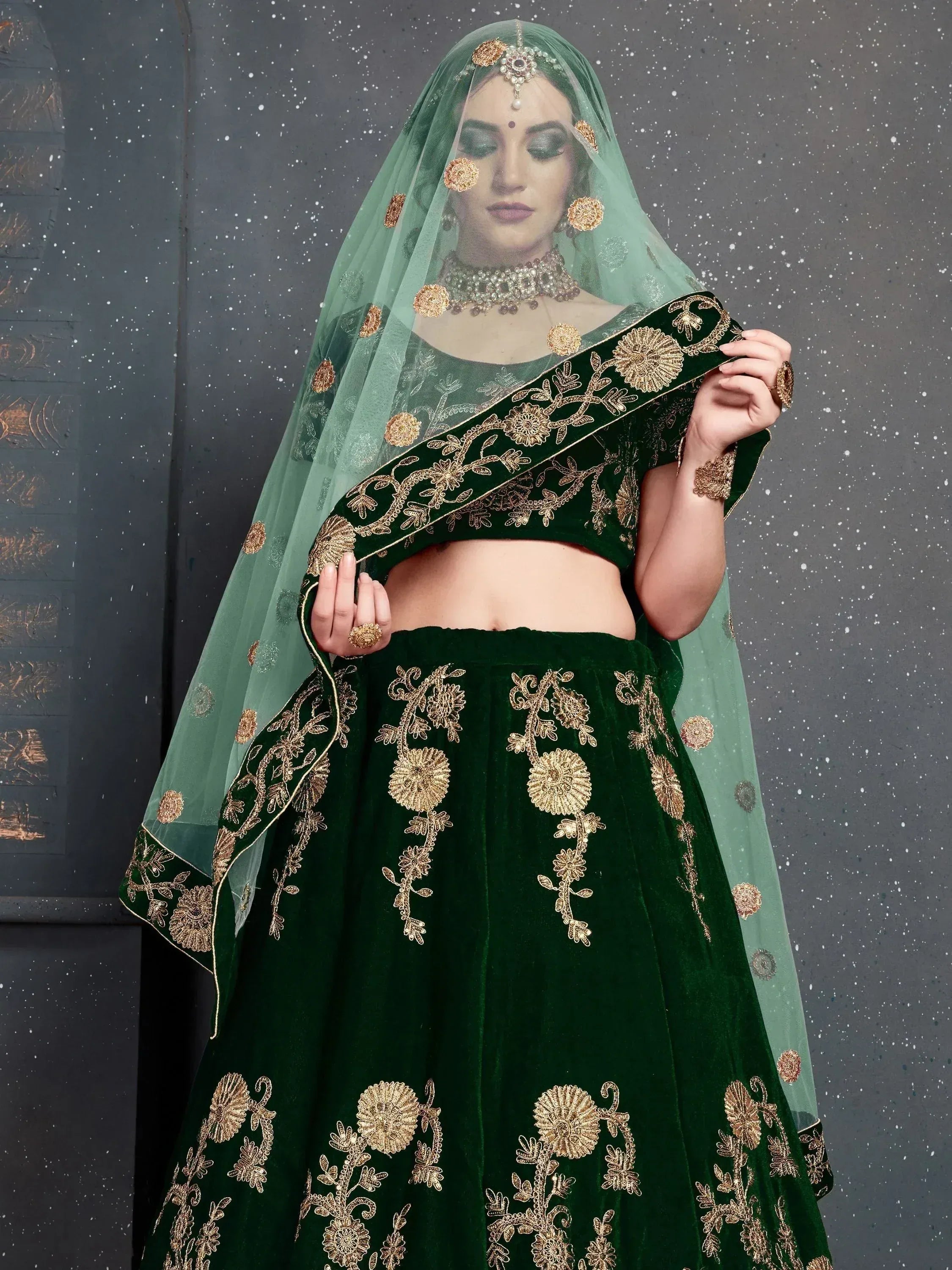 Emerald green velvet lehenga choli with gold floral embroidery and matching dupatta for Indian ethnic wear