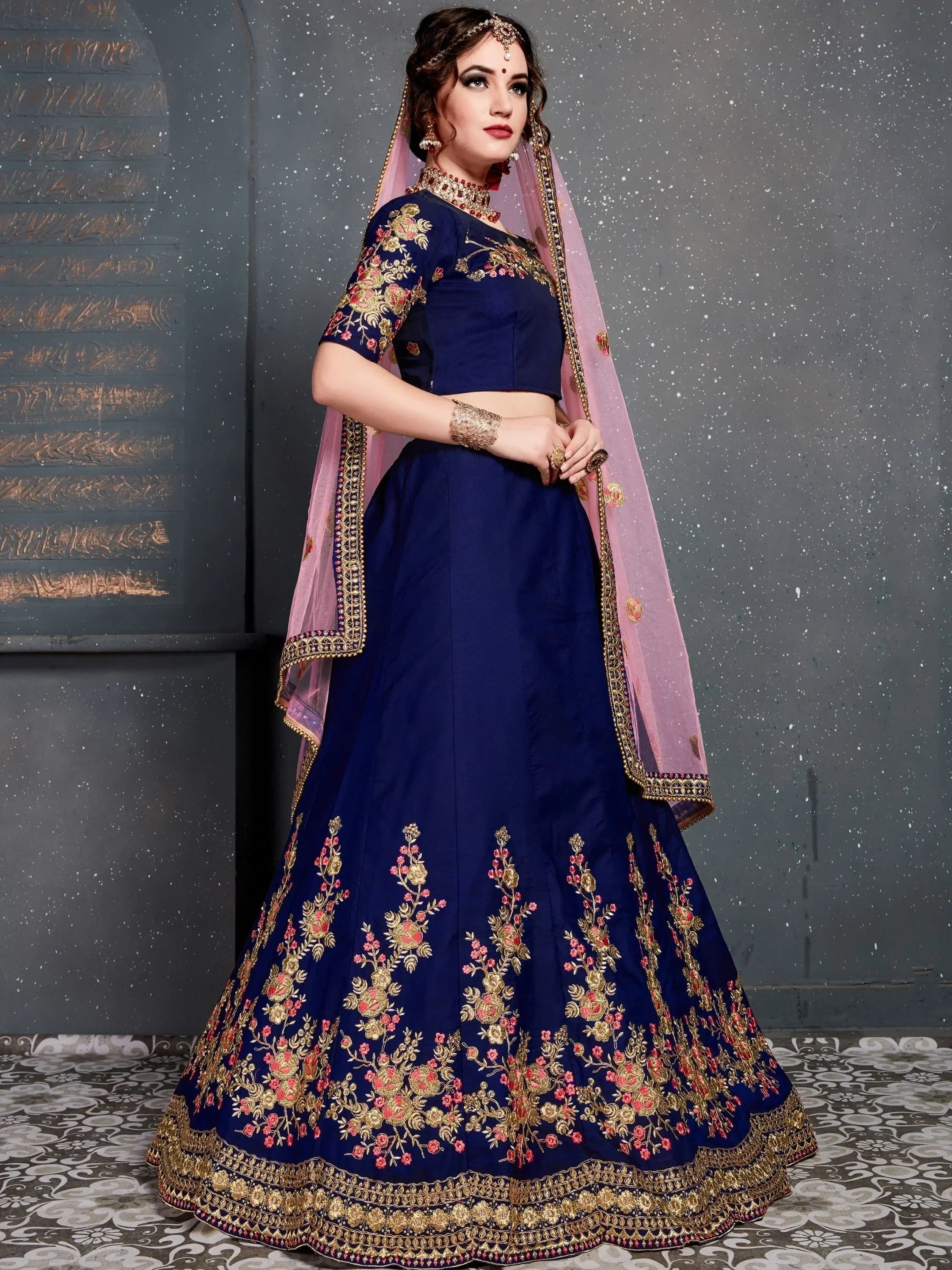 Navy blue embroidered lehenga choli with pink dupatta, floral gold detailing, perfect for Indian weddings