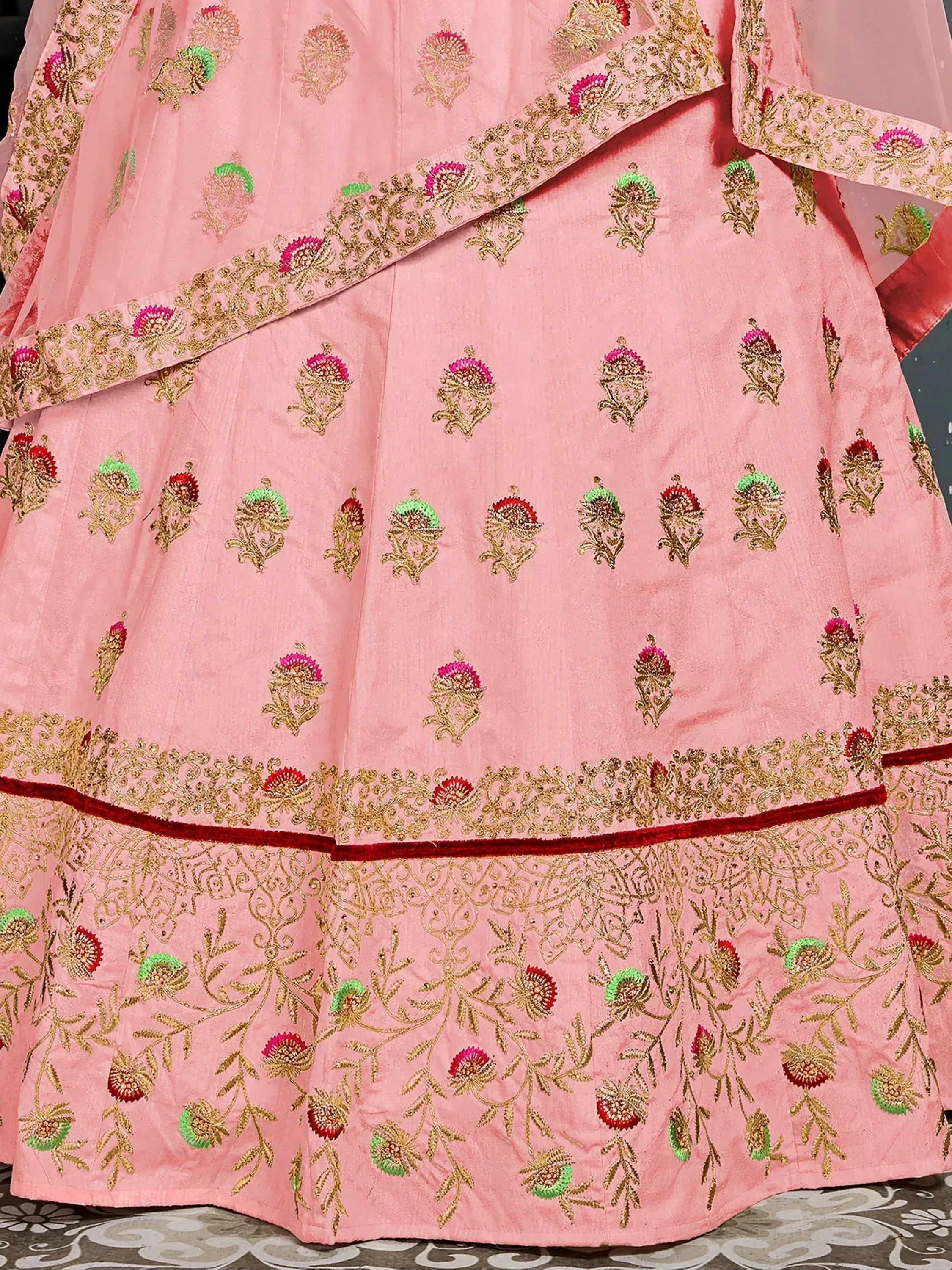 Pink designer lehenga choli with gold floral embroidery and red velvet border, ethnic wear for women