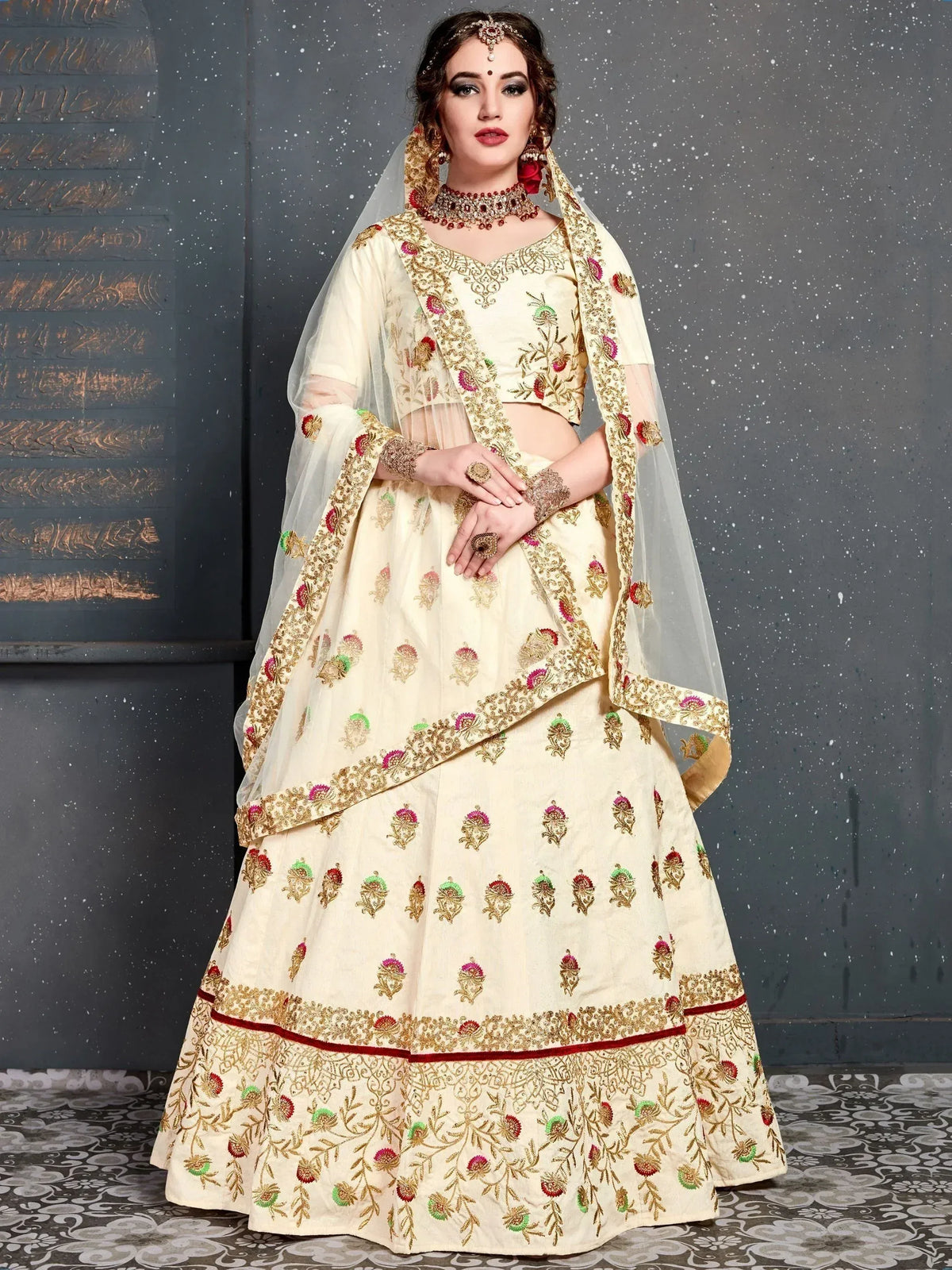 Cream embroidered lehenga choli with floral motifs, dupatta, and traditional jewelry for Indian weddings.