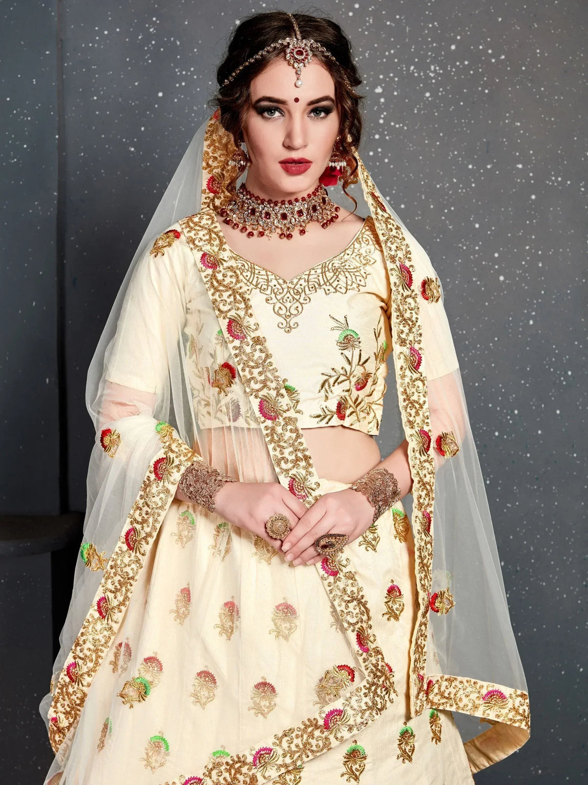 Cream embroidered lehenga choli with floral motifs, dupatta, and traditional jewelry for Indian weddings
