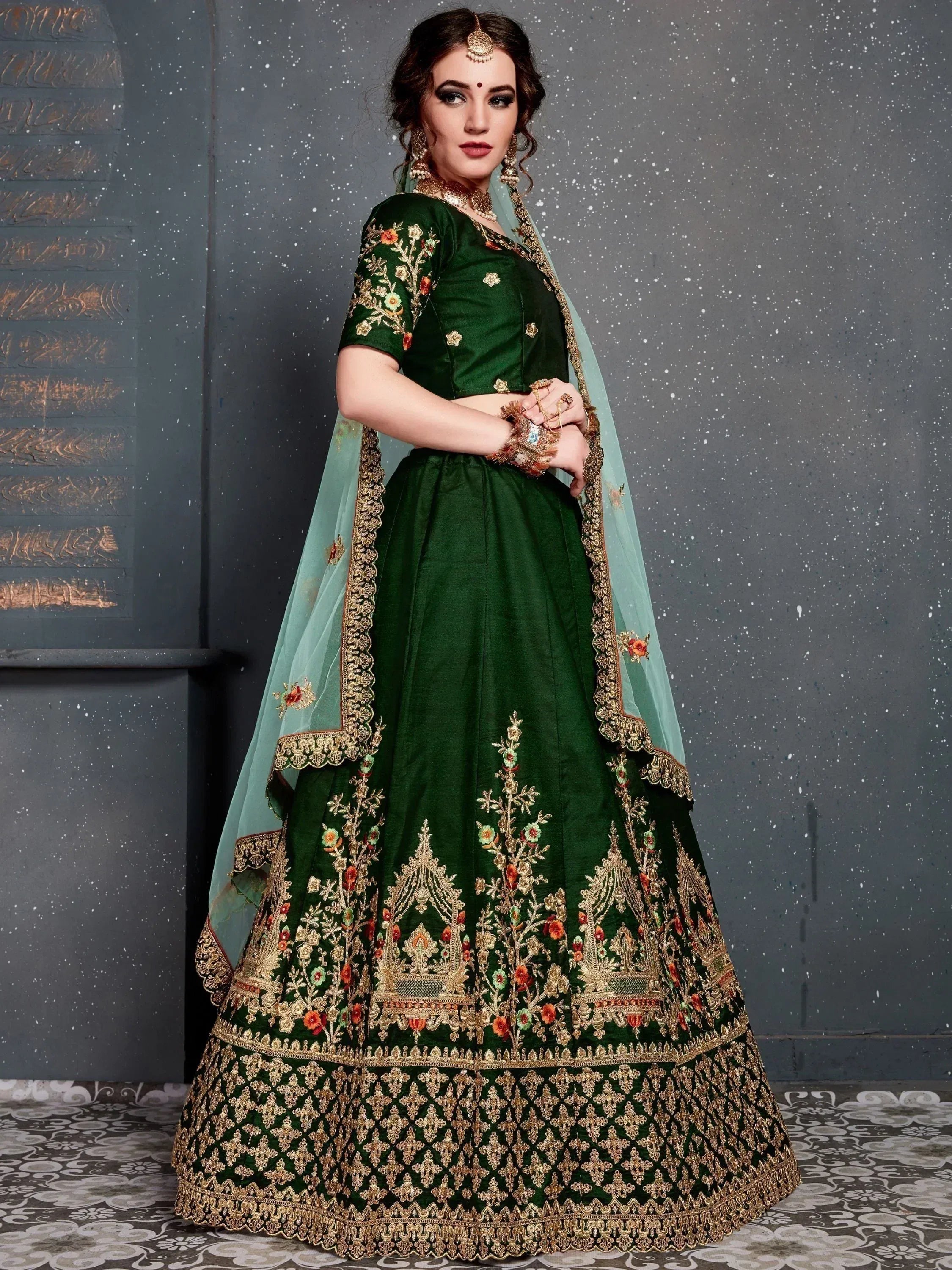 Emerald green designer lehenga choli with gold floral embroidery and matching dupatta for Indian weddings