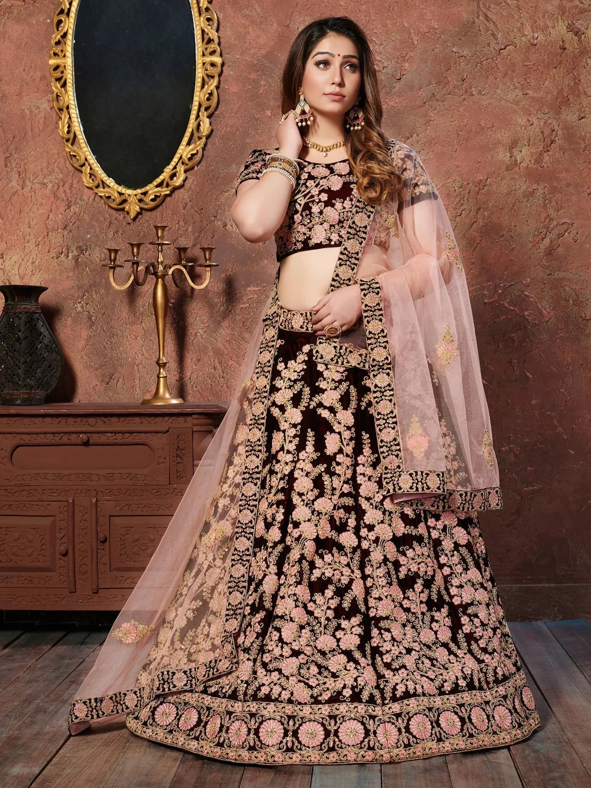 Elegant maroon lehenga choli with pink floral embroidery and sheer dupatta, perfect for Indian weddings and festive occasions.