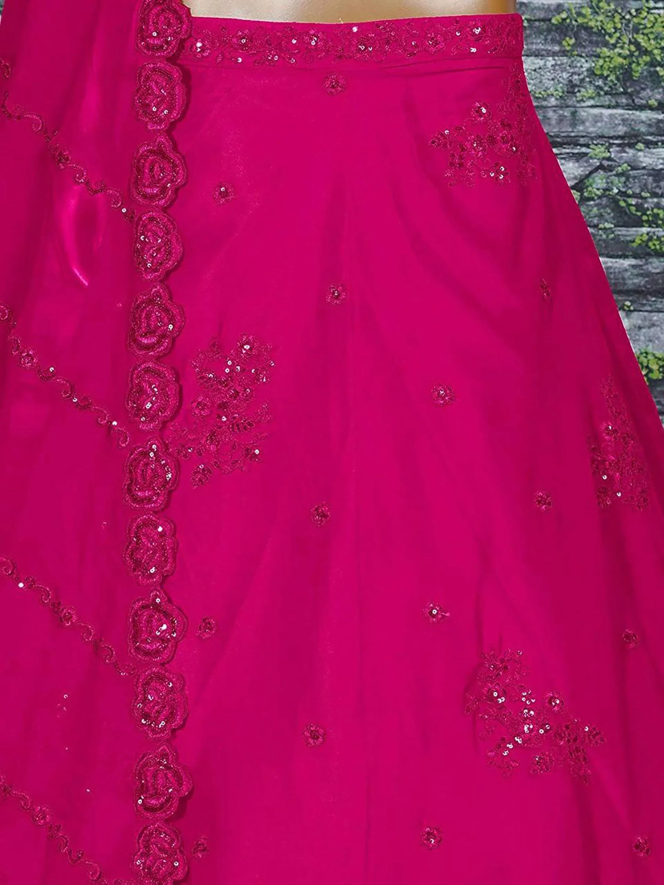 Fuchsia ethnic gown with floral sequin embroidery and scalloped border, ideal for Indian festive wear