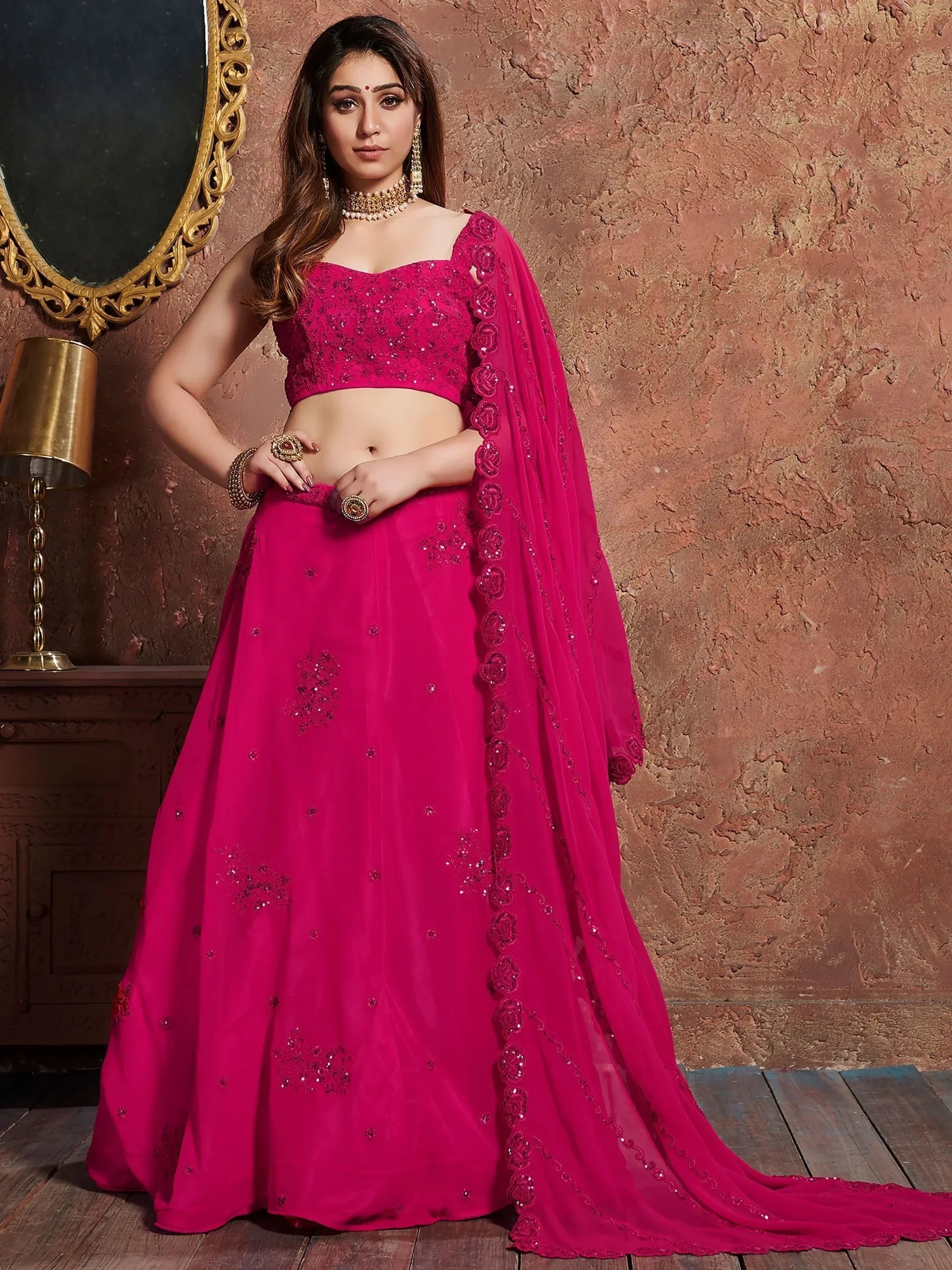 Fuchsia pink designer lehenga choli with sequin embroidery and floral dupatta, perfect for Indian weddings and festive occasions.