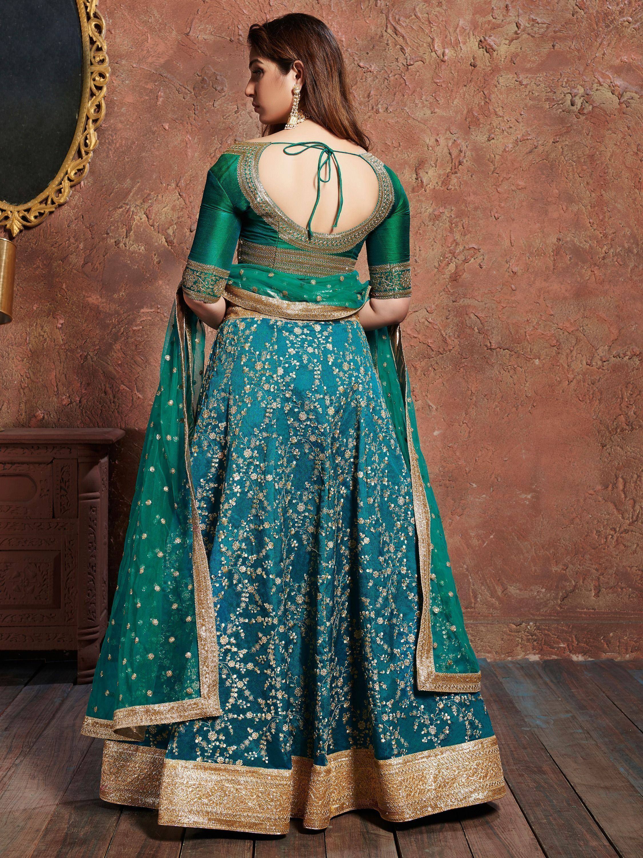 Emerald green lehenga choli with gold floral embroidery and open back design, ideal for Indian ethnic wear.
