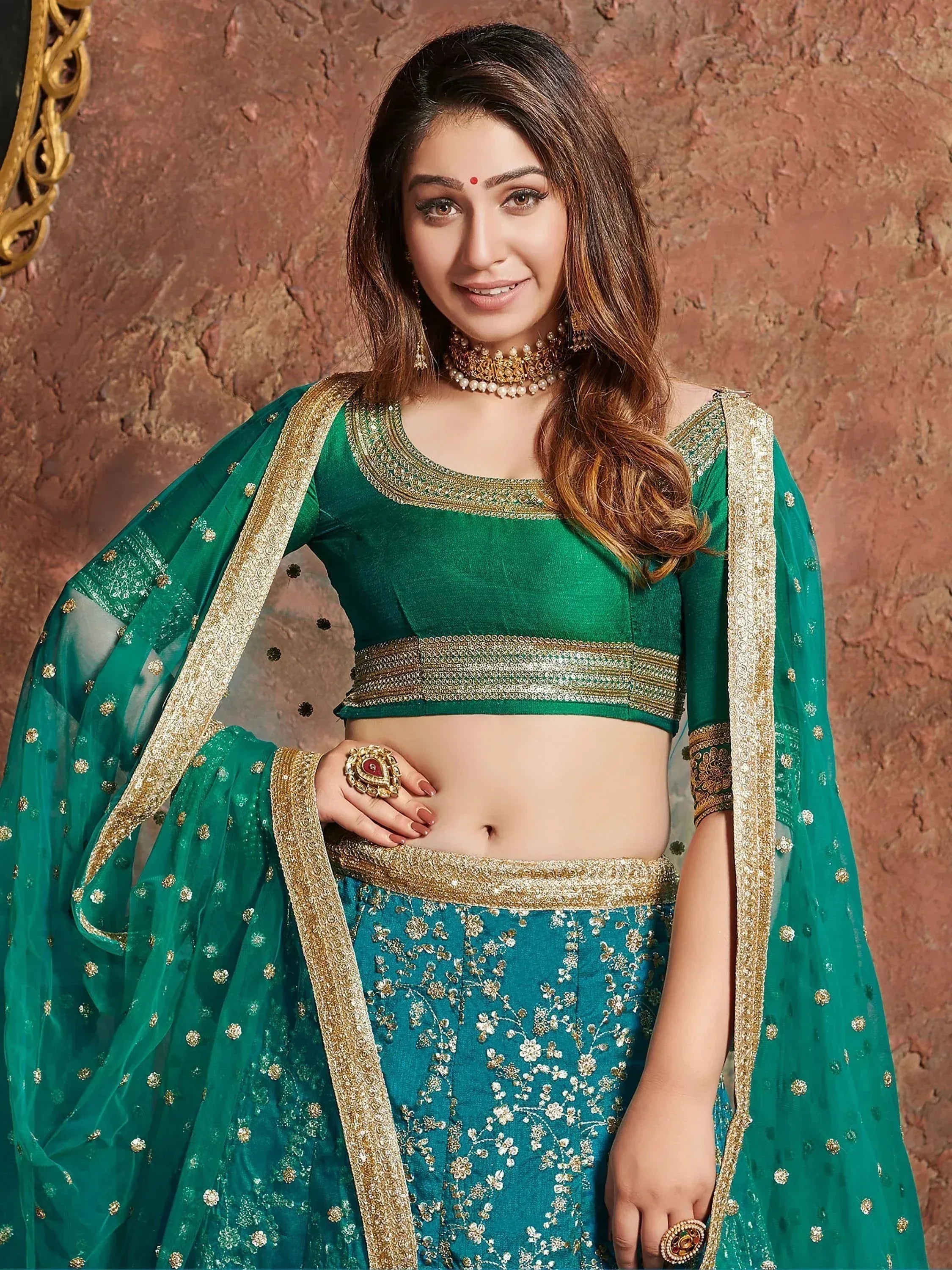 Emerald green designer lehenga choli with gold embroidery and sheer dupatta for Indian ethnic wear