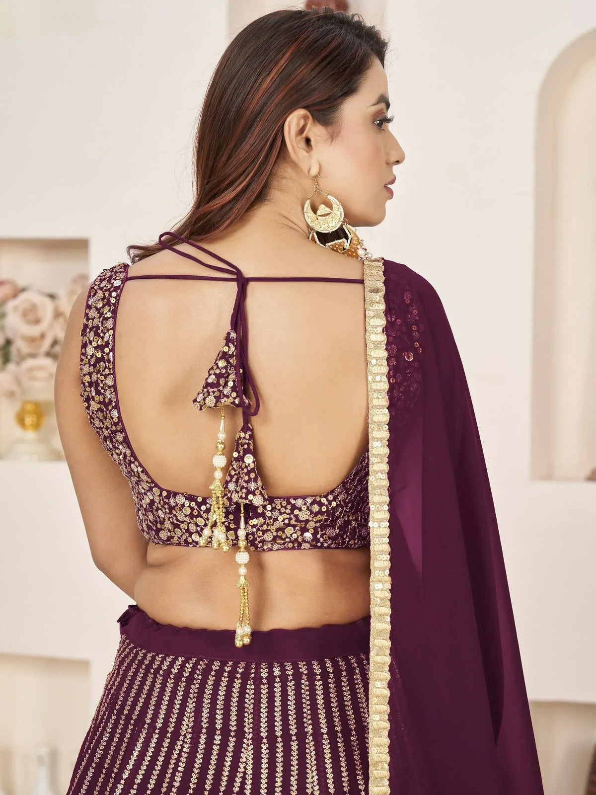 Purple designer lehenga choli with gold sequins, open back, and tassels for Indian ethnic wear