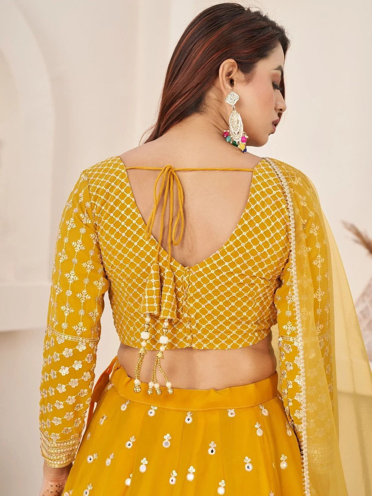 Mustard yellow lehenga choli with back tie blouse, floral embroidery, and mirror work for Indian ethnic wear