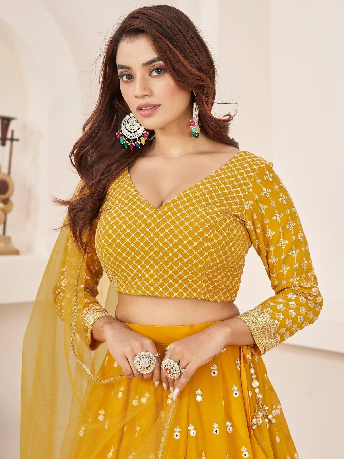 Yellow designer lehenga choli with intricate embroidery and matching dupatta, perfect for Indian ethnic wear