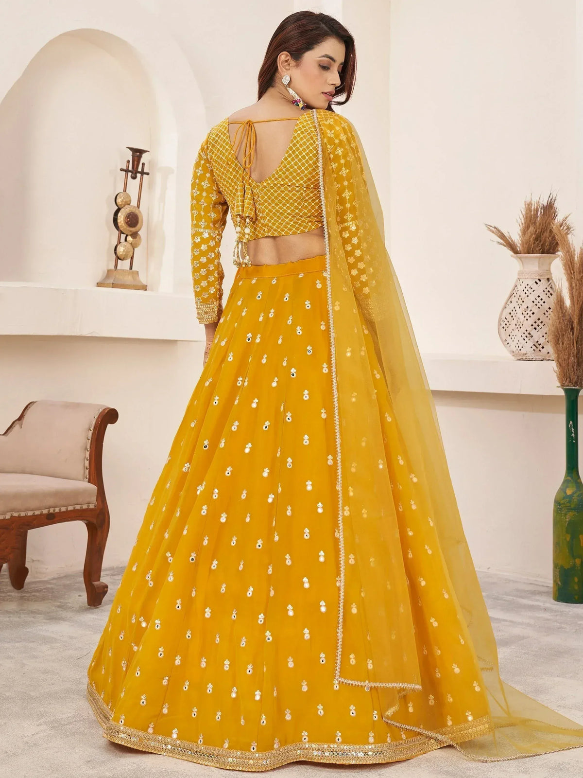 Yellow designer lehenga choli with floral embroidery and sheer dupatta, ethnic wear for women
