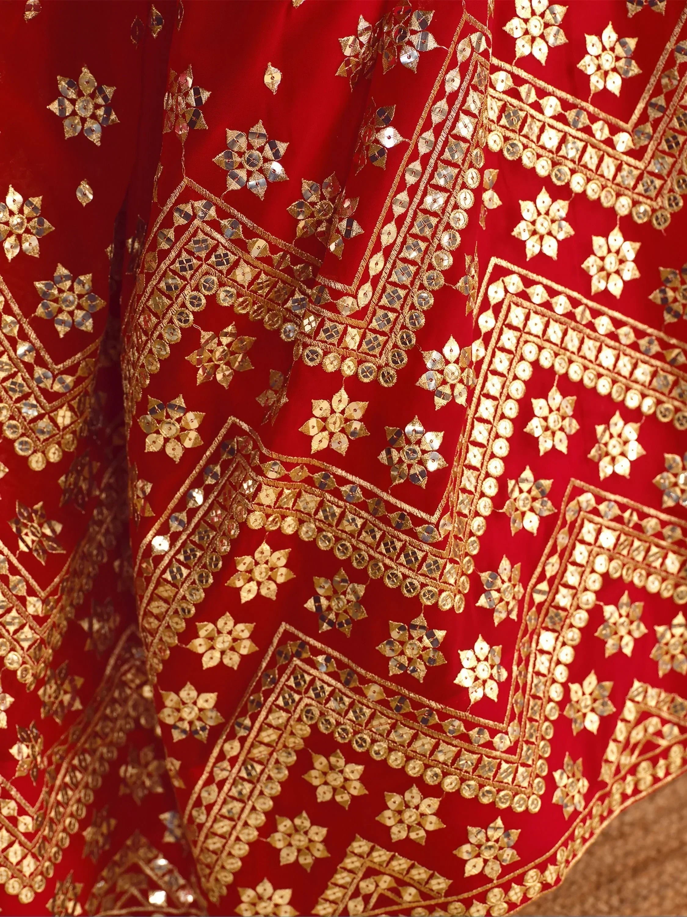 Red ethnic wear with gold mirror work and floral embroidery, perfect for Indian festivals and weddings.