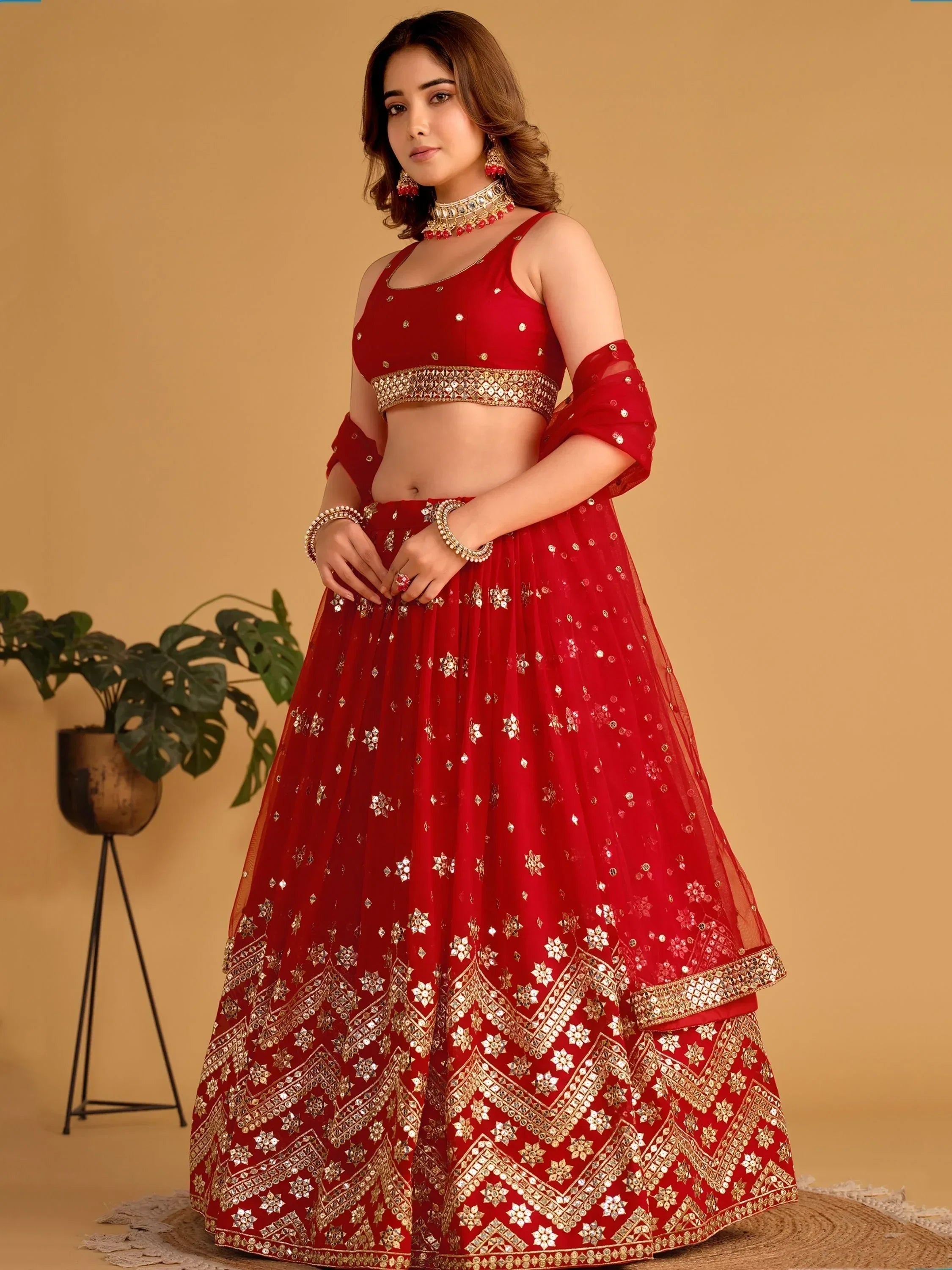 Red designer lehenga choli with gold mirror work, perfect for Indian ethnic wear occasions