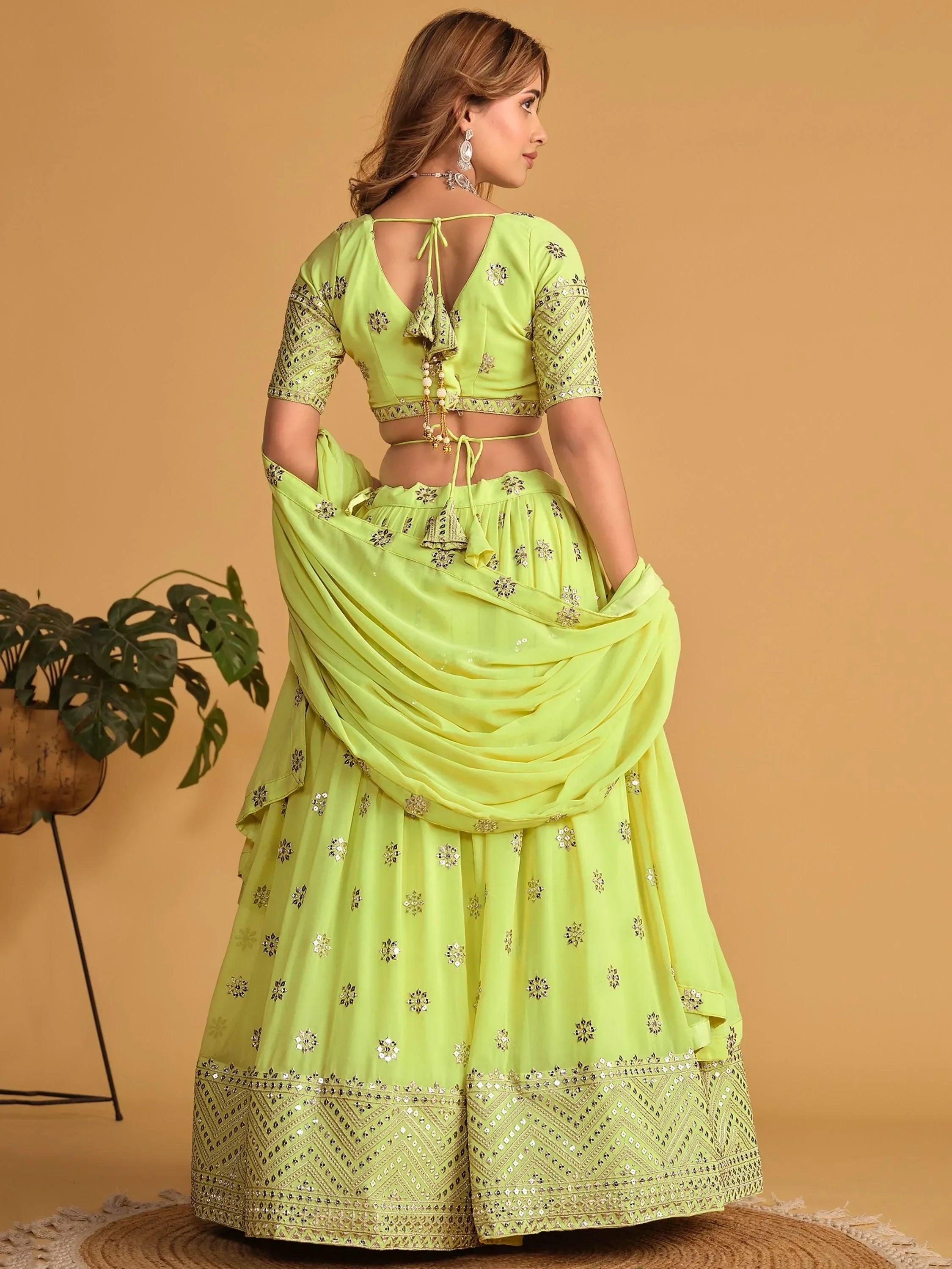Lime green designer lehenga choli with mirror work and back tie blouse, perfect for Indian ethnic wear