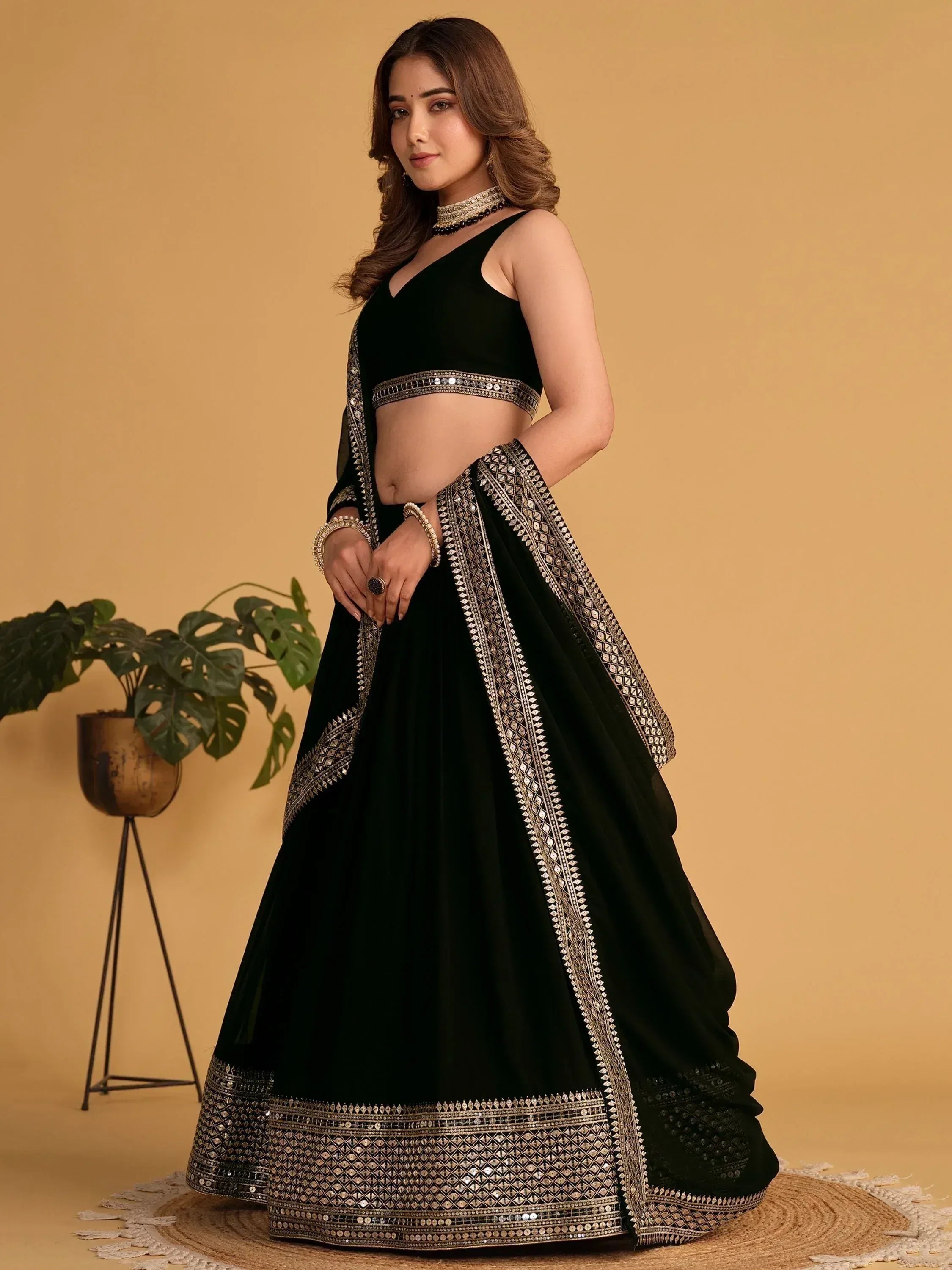Black designer lehenga choli with gold mirror work, perfect for Indian ethnic wear events