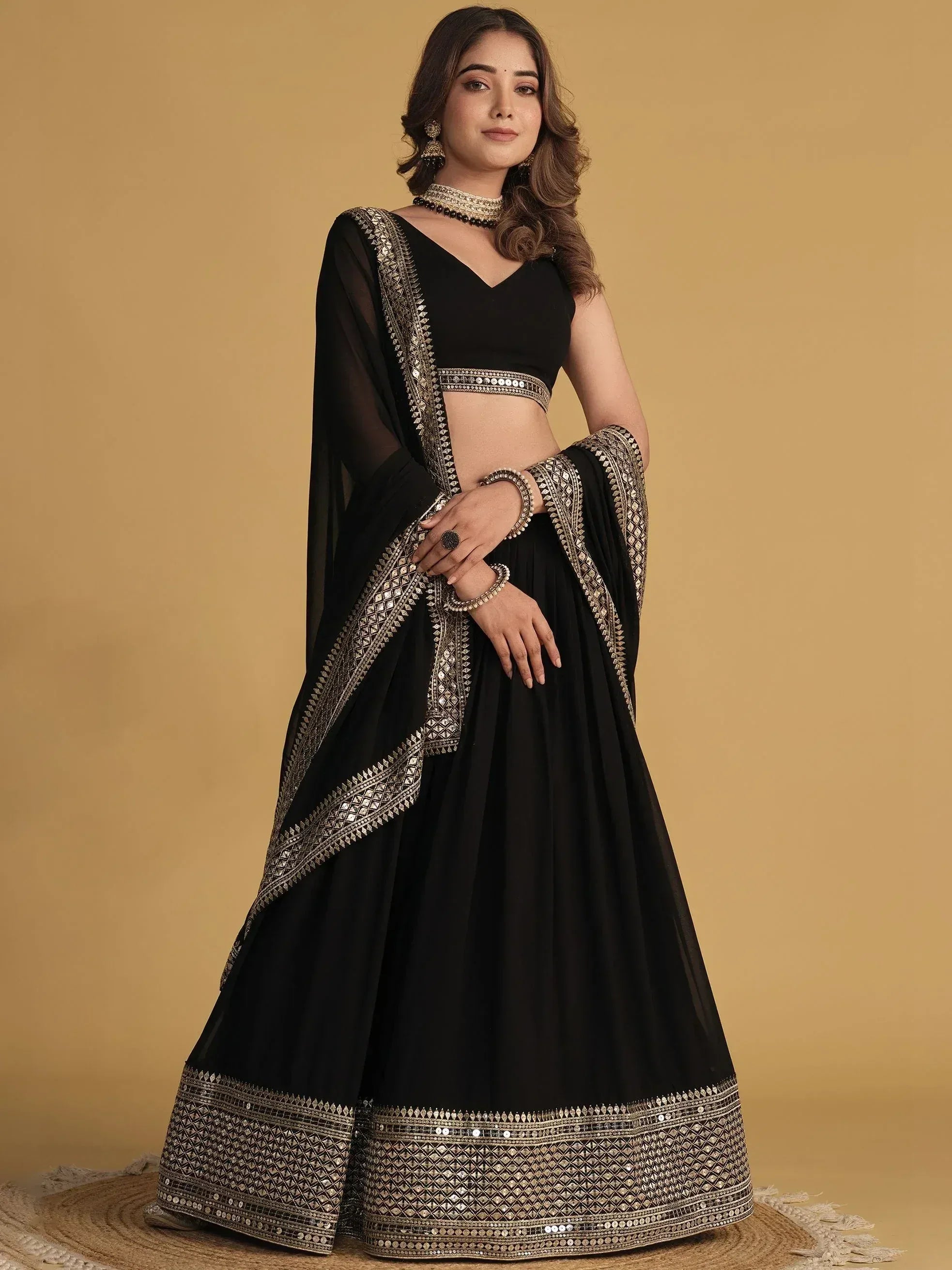 Black designer lehenga choli with gold mirror work, perfect for Indian ethnic wear and festive occasions.