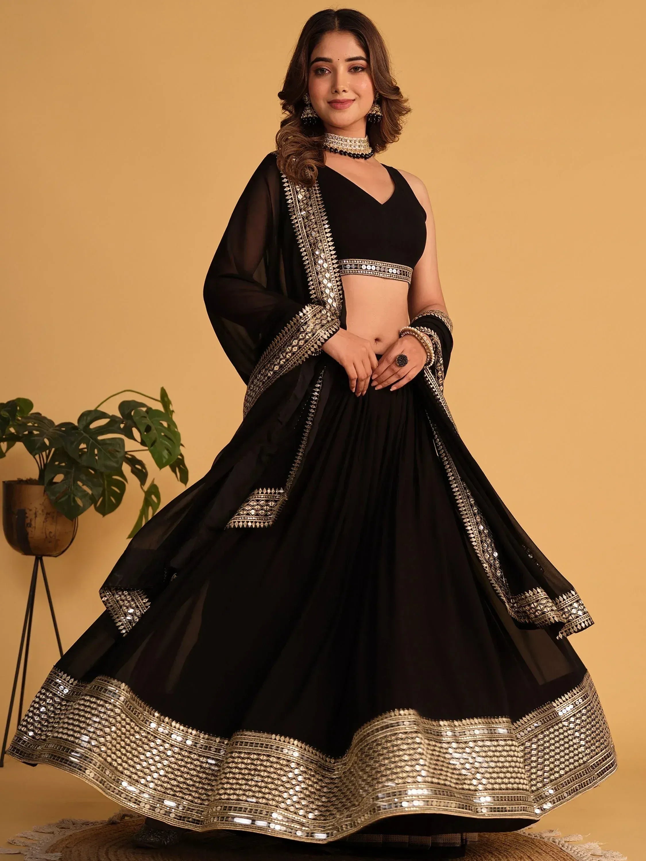 Black lehenga choli with gold mirror work, perfect for Indian ethnic wear and festive occasions.