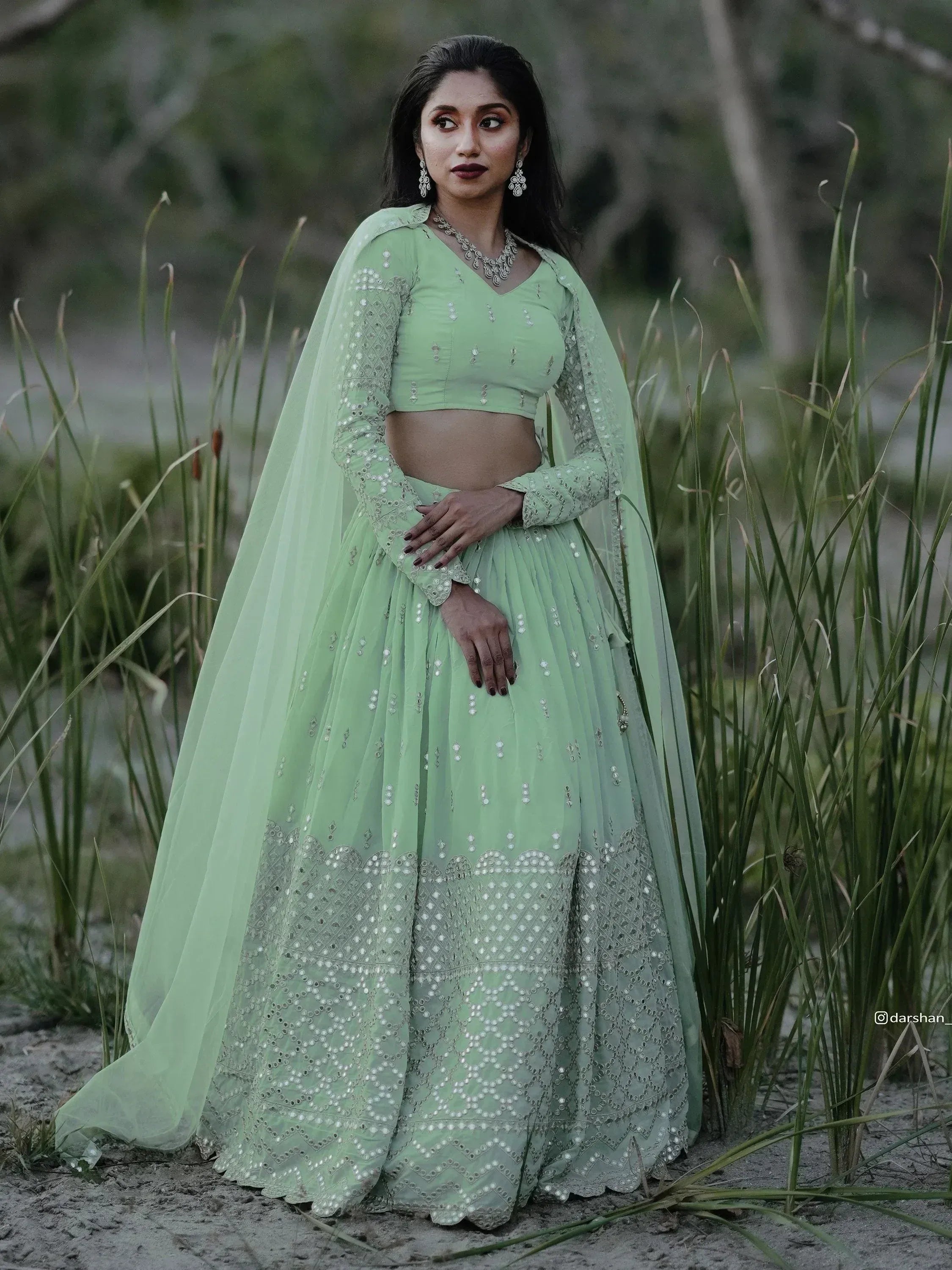 Mint green designer lehenga choli with mirror work, perfect for Indian ethnic wear and festive occasions.