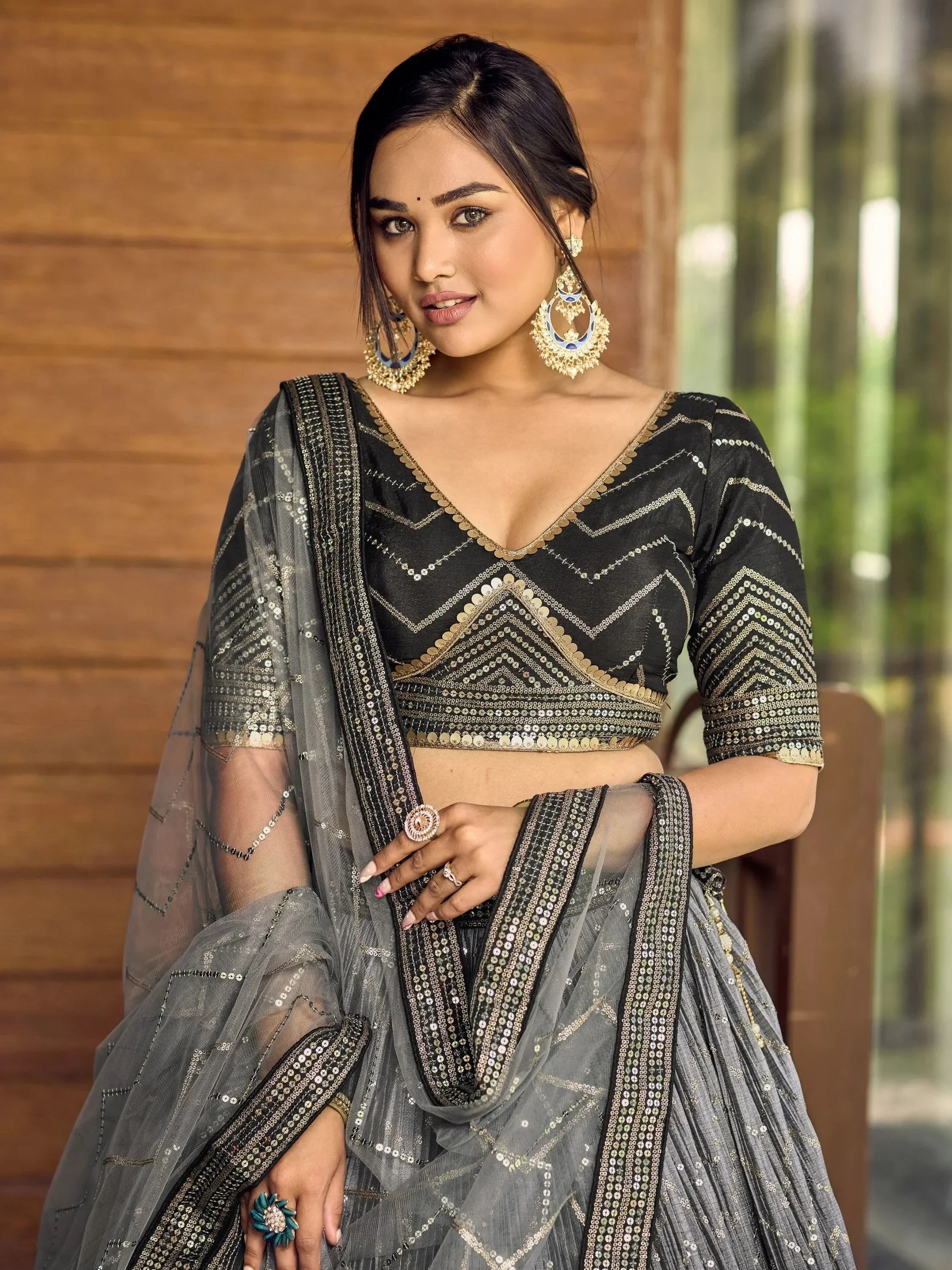 Black and gold sequin lehenga choli with sheer dupatta, perfect for Indian ethnic wear events
