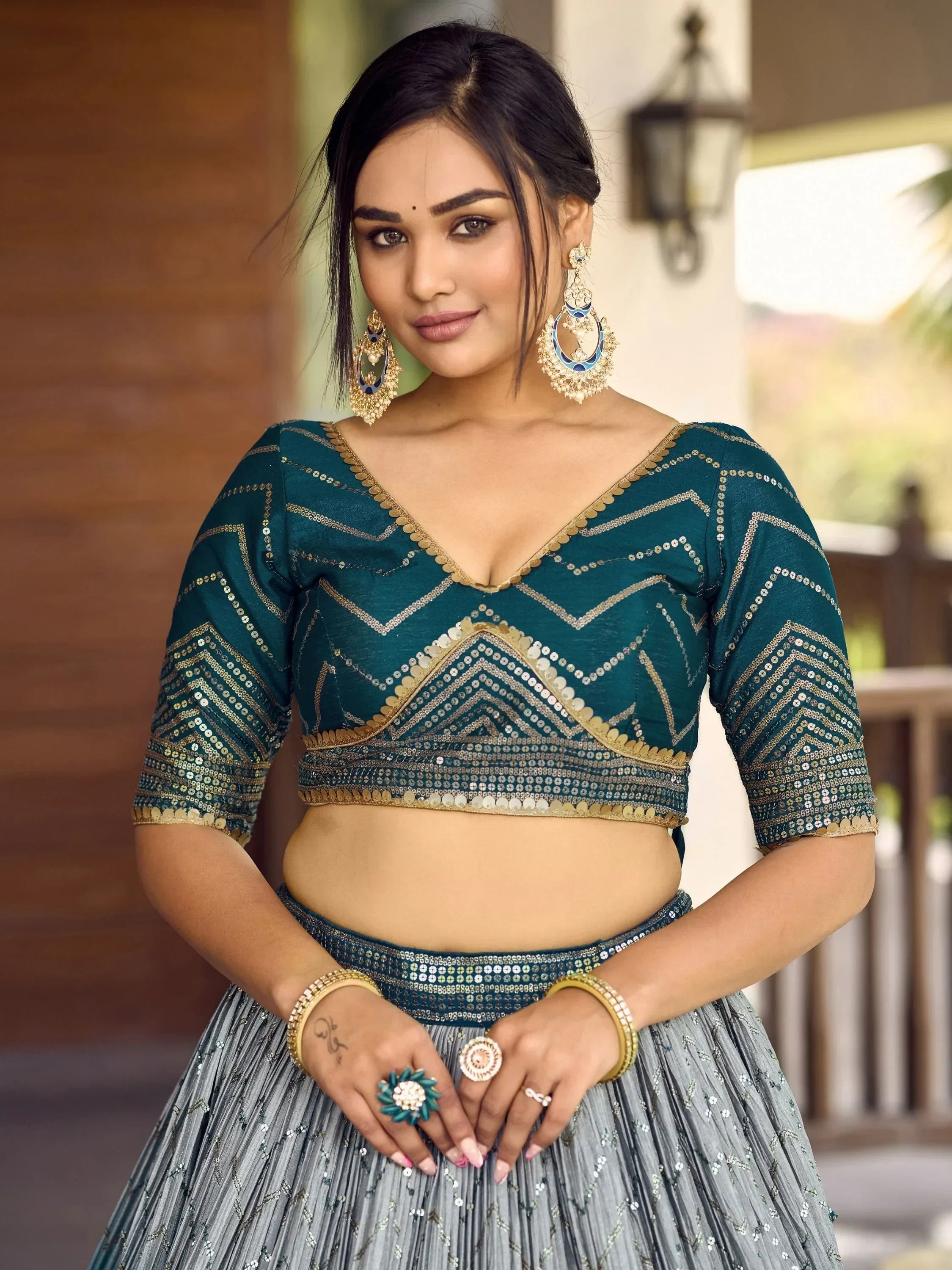 Teal sequin lehenga choli with gold embroidery, perfect for Indian ethnic wear and festive occasions.