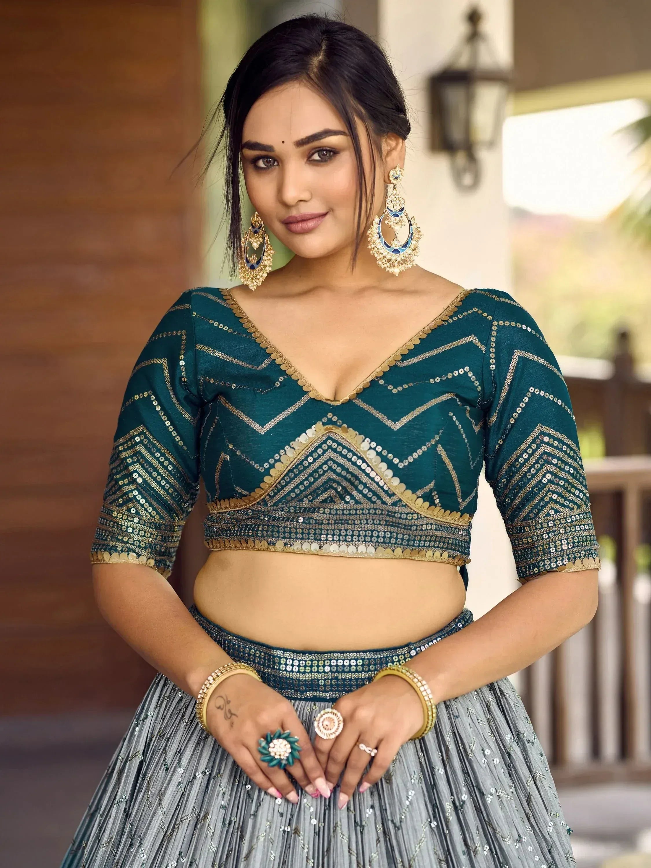 Teal sequin lehenga choli with gold embroidery, perfect for Indian ethnic wear and festive occasions.