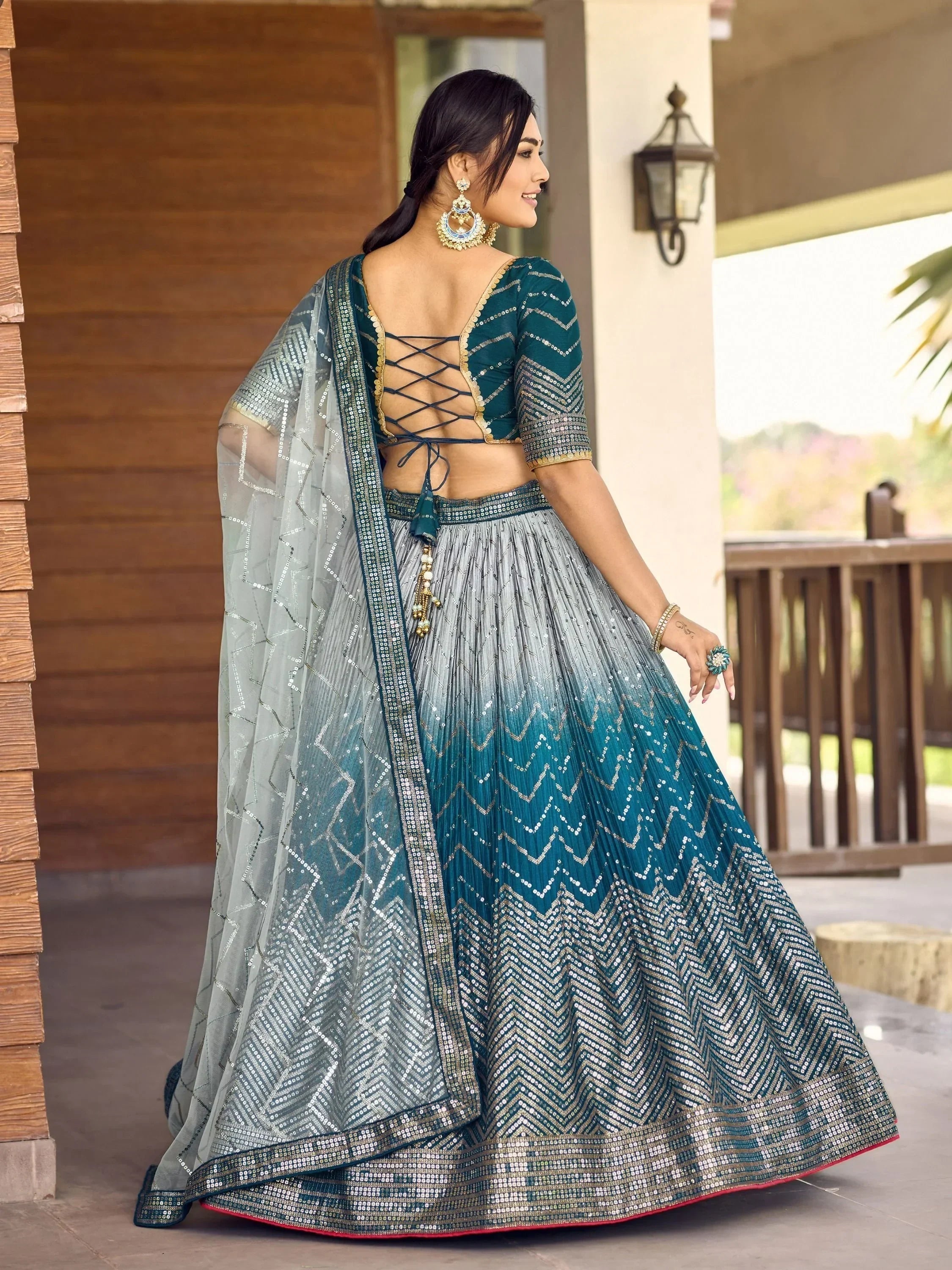 Teal and silver sequin lehenga choli with crisscross back blouse and sheer dupatta, ethnic Indian wear