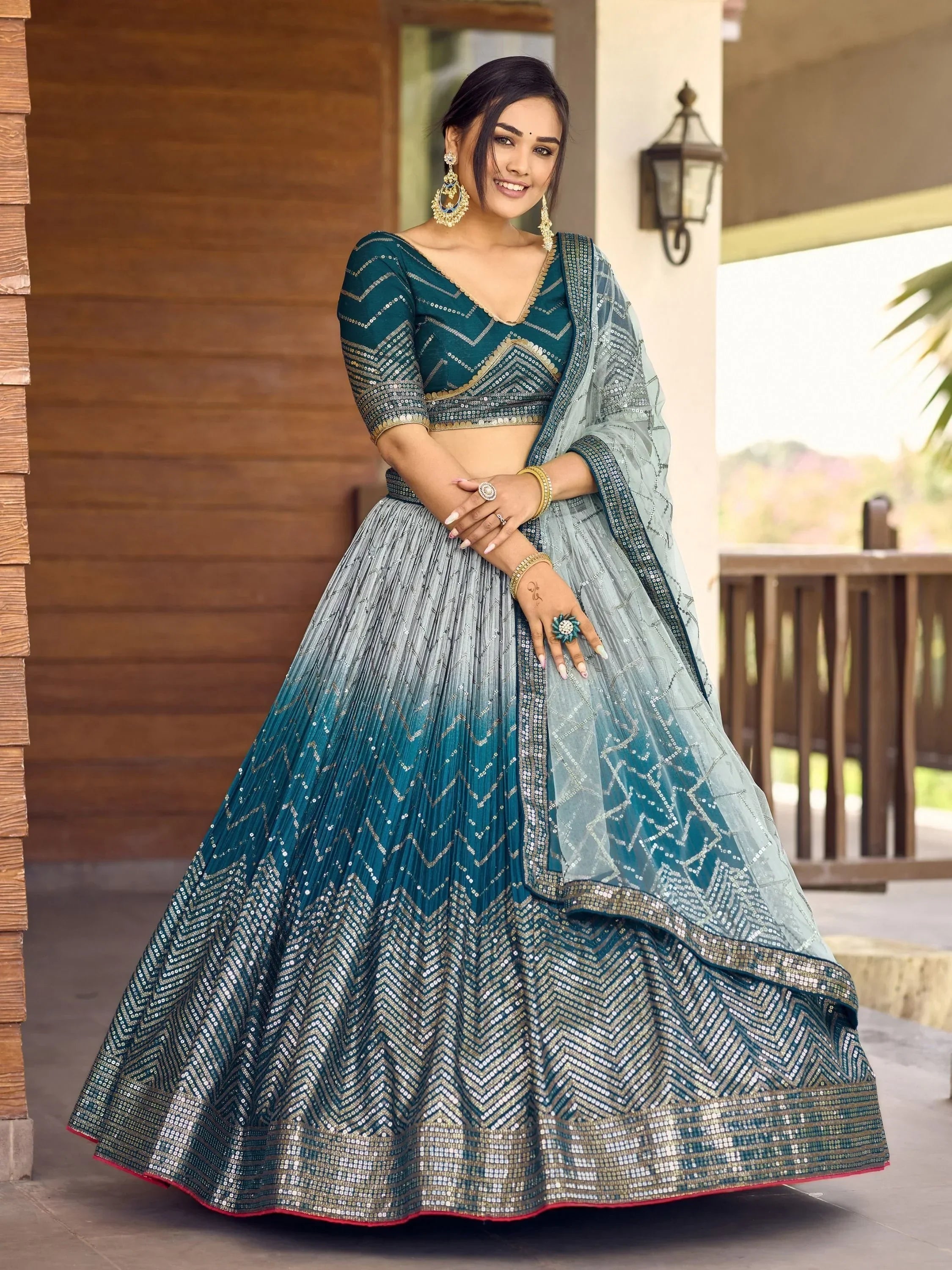 Teal and silver sequin lehenga choli with chevron patterns, perfect for Indian weddings and festive occasions.