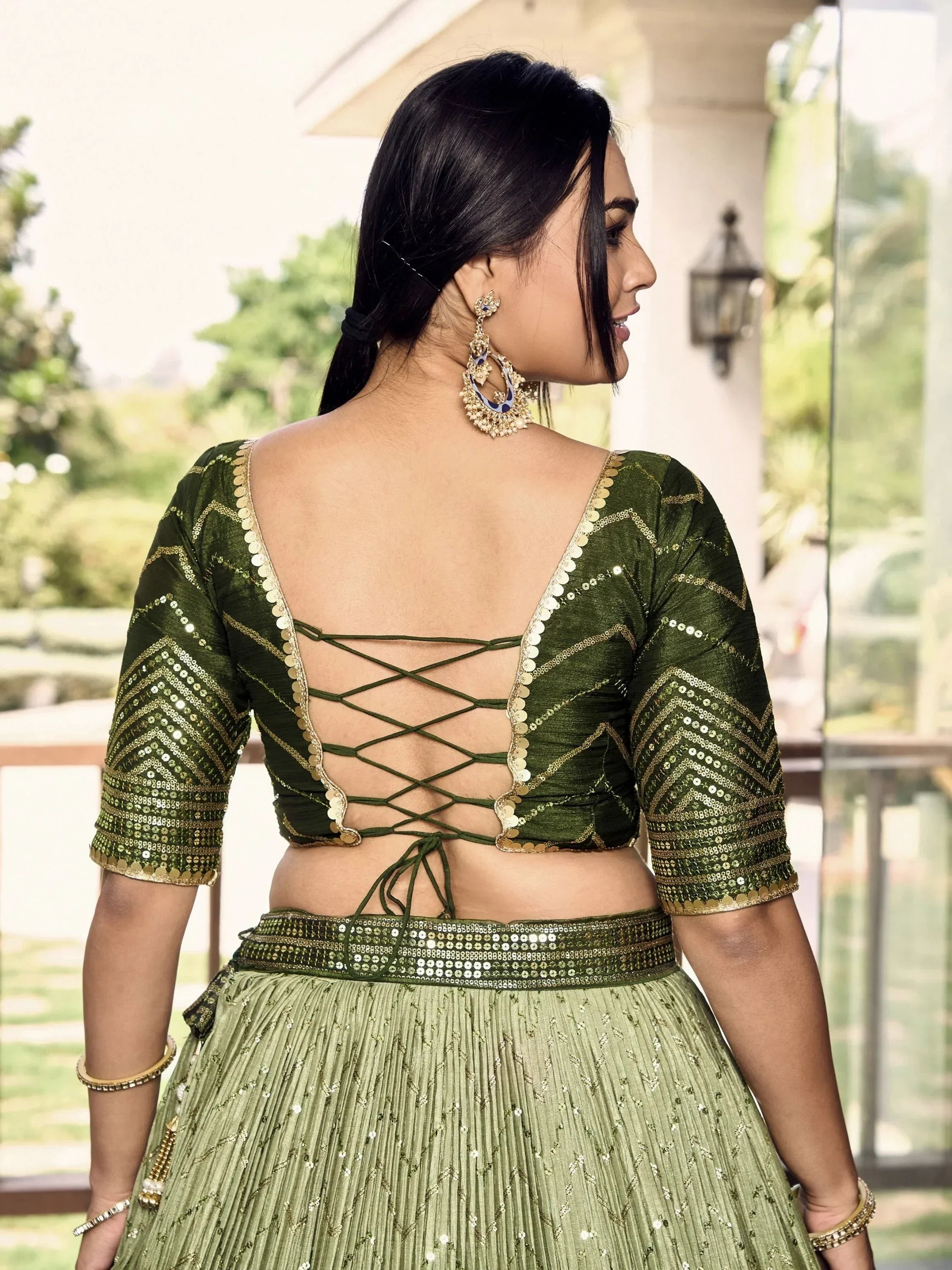 Green sequin lehenga choli with back crisscross design, perfect for Indian ethnic wear events