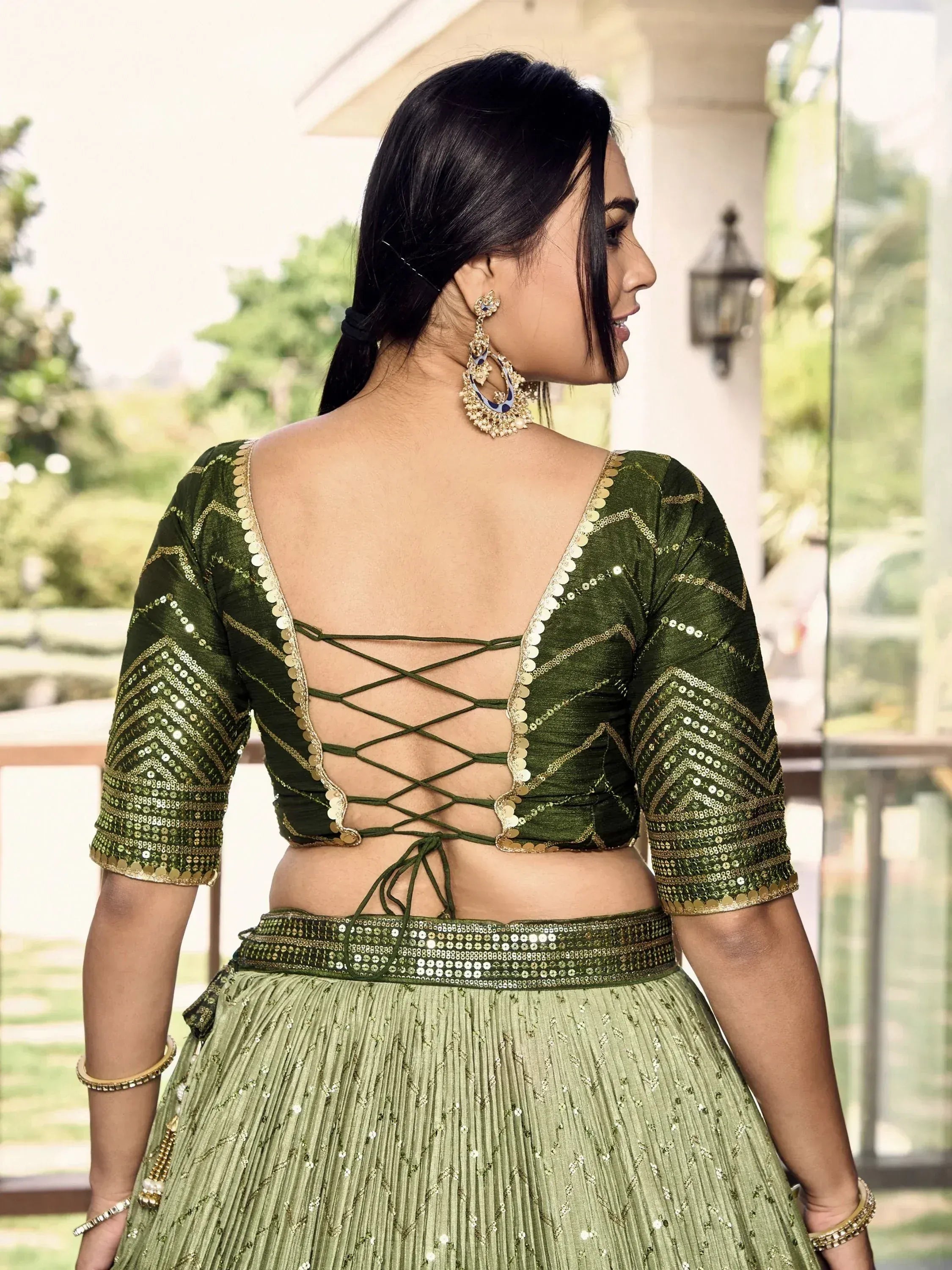 Green sequin lehenga choli with back crisscross design, perfect for Indian ethnic wear events