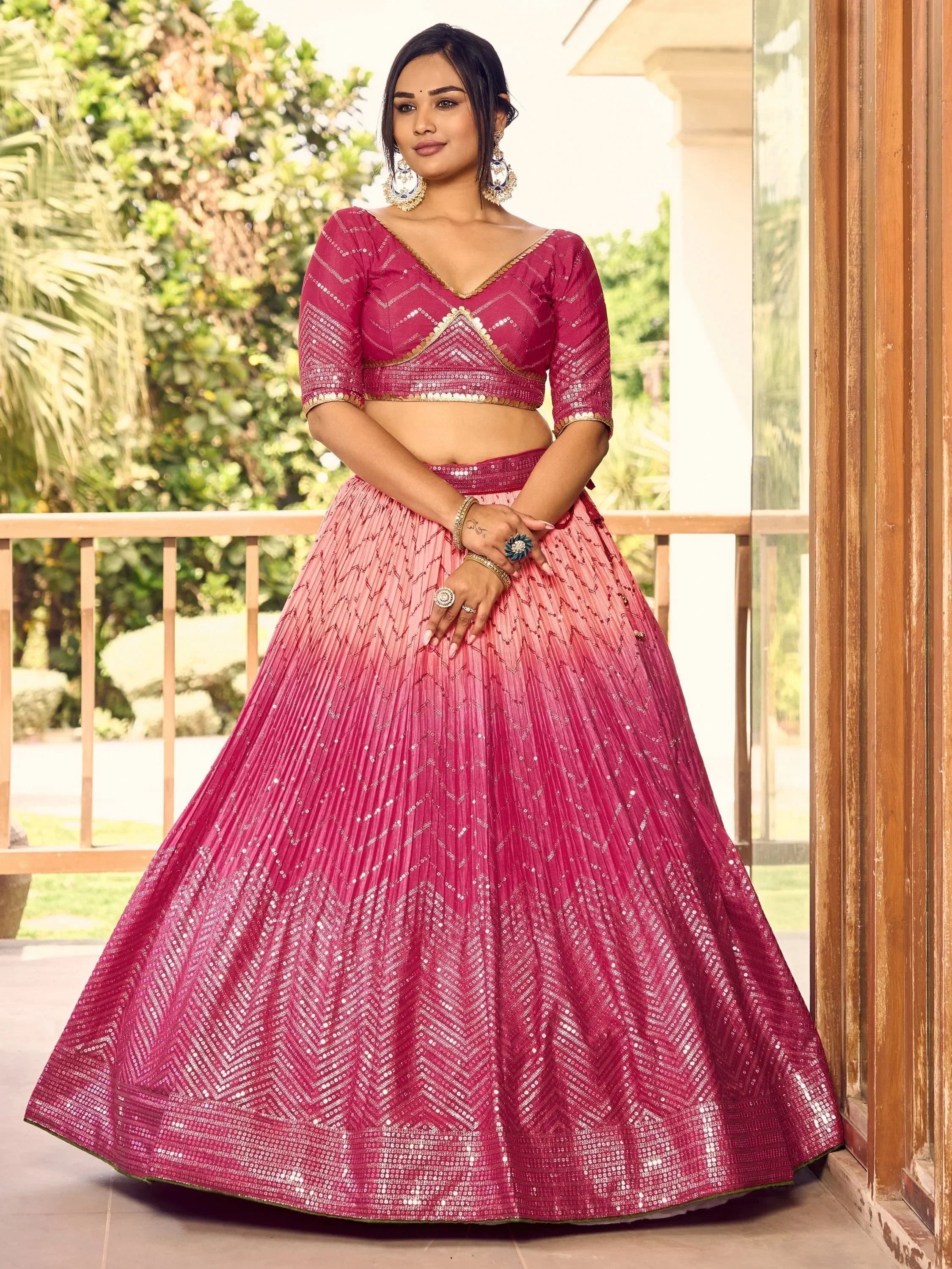 Pink sequin lehenga choli with V-neck blouse, perfect for Indian weddings and festive occasions.