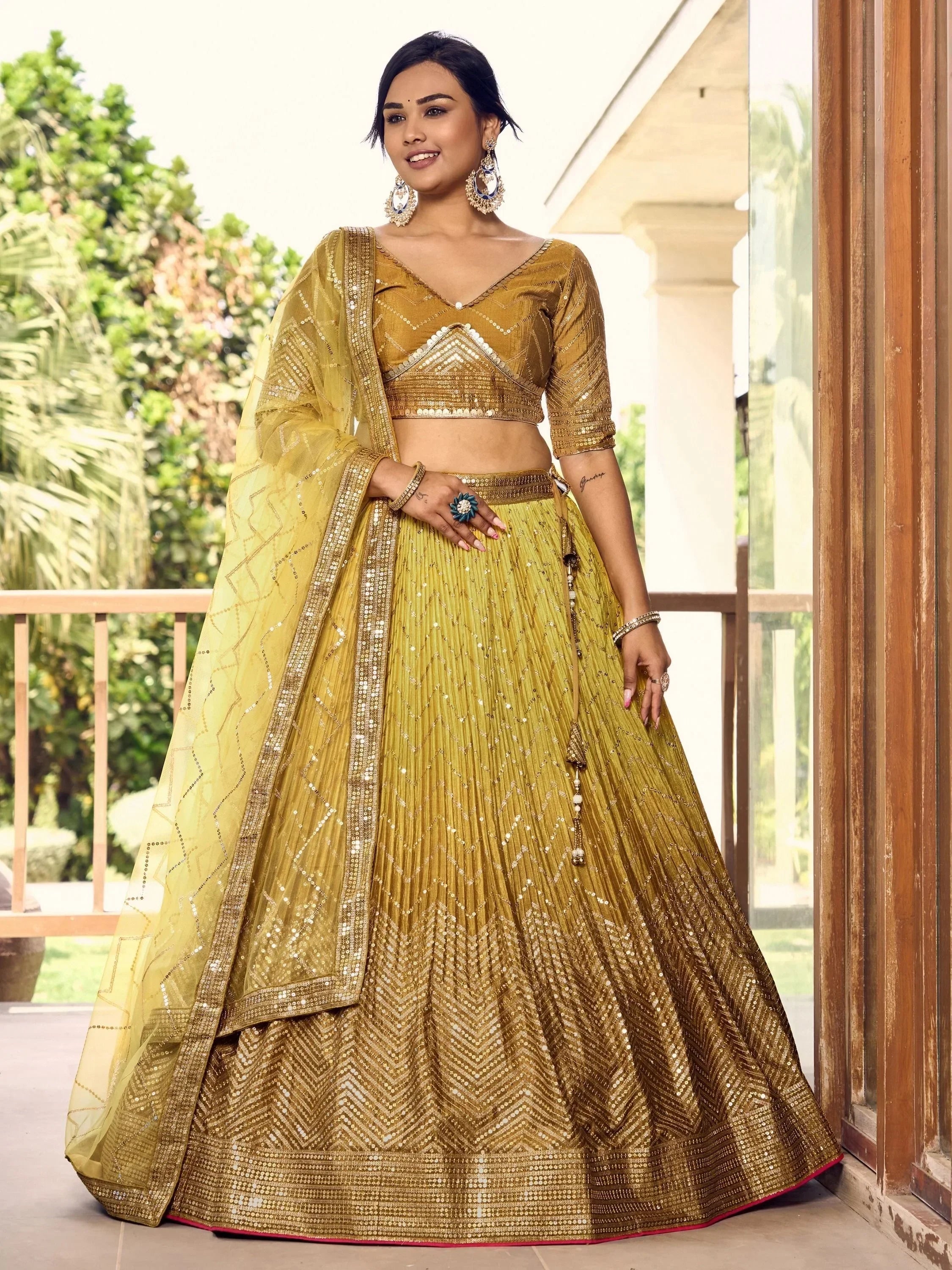 Golden designer lehenga choli with sequin work, perfect for Indian ethnic wear and festive occasions.