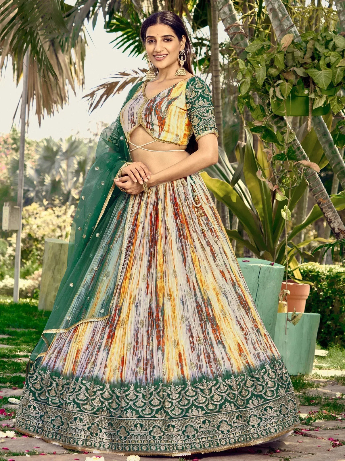 Woman in vibrant printed lehenga choli with green dupatta, perfect for Indian ethnic wear occasions