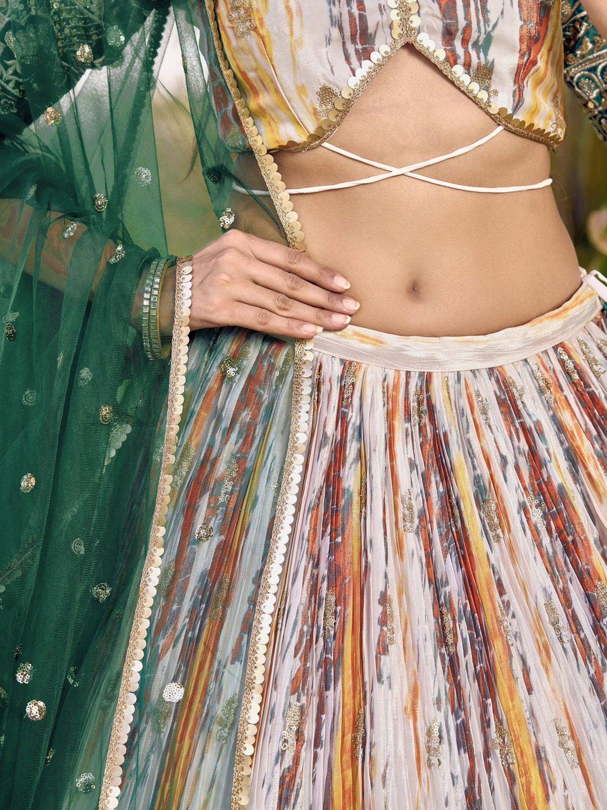 Designer lehenga choli with printed pleated skirt, gold embellishments, and green dupatta for ethnic wear