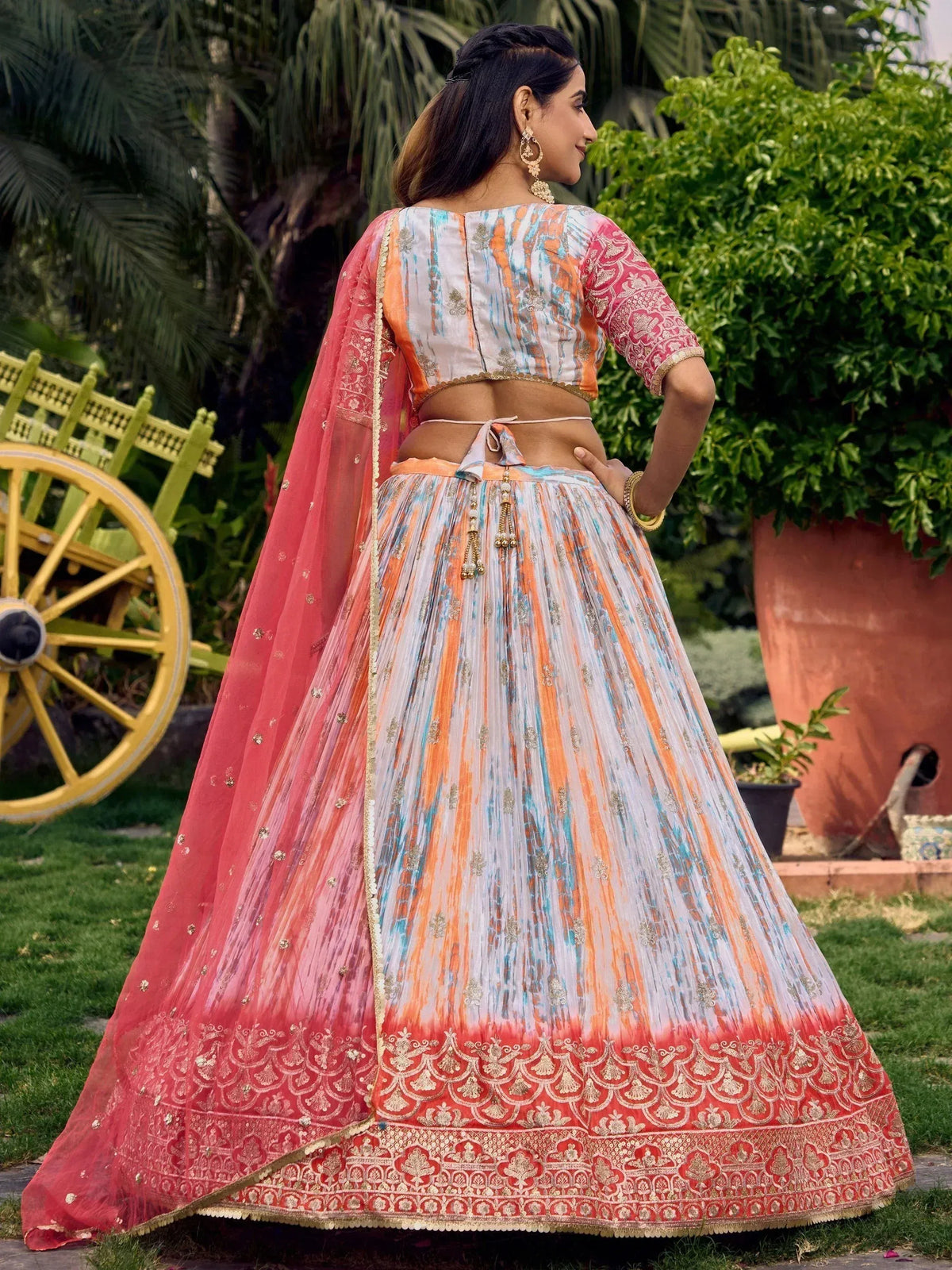 Woman in colorful designer lehenga choli with embroidered dupatta, perfect for Indian ethnic occasions
