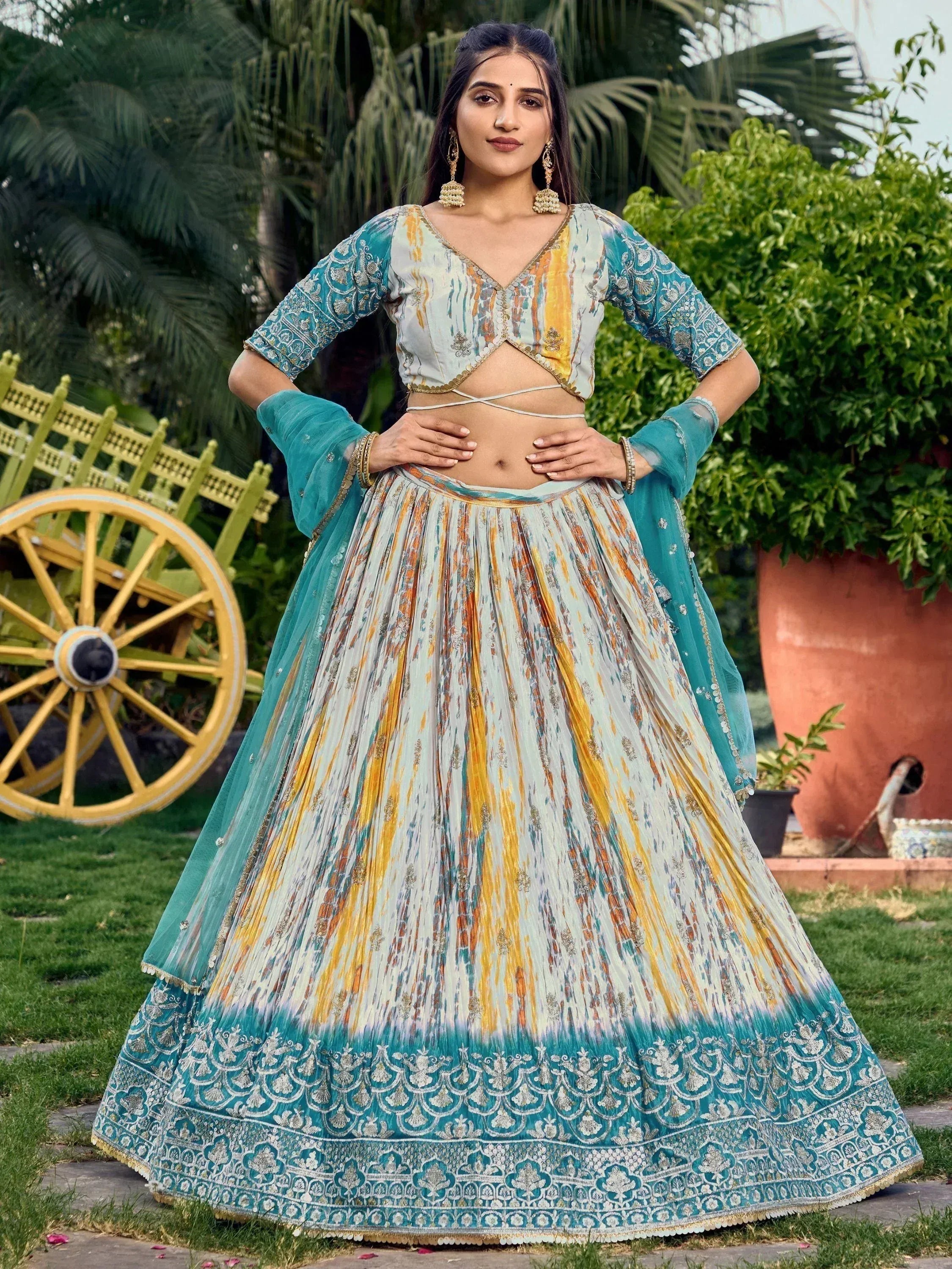 Teal and gold printed lehenga choli with embroidered dupatta, perfect for Indian ethnic occasions
