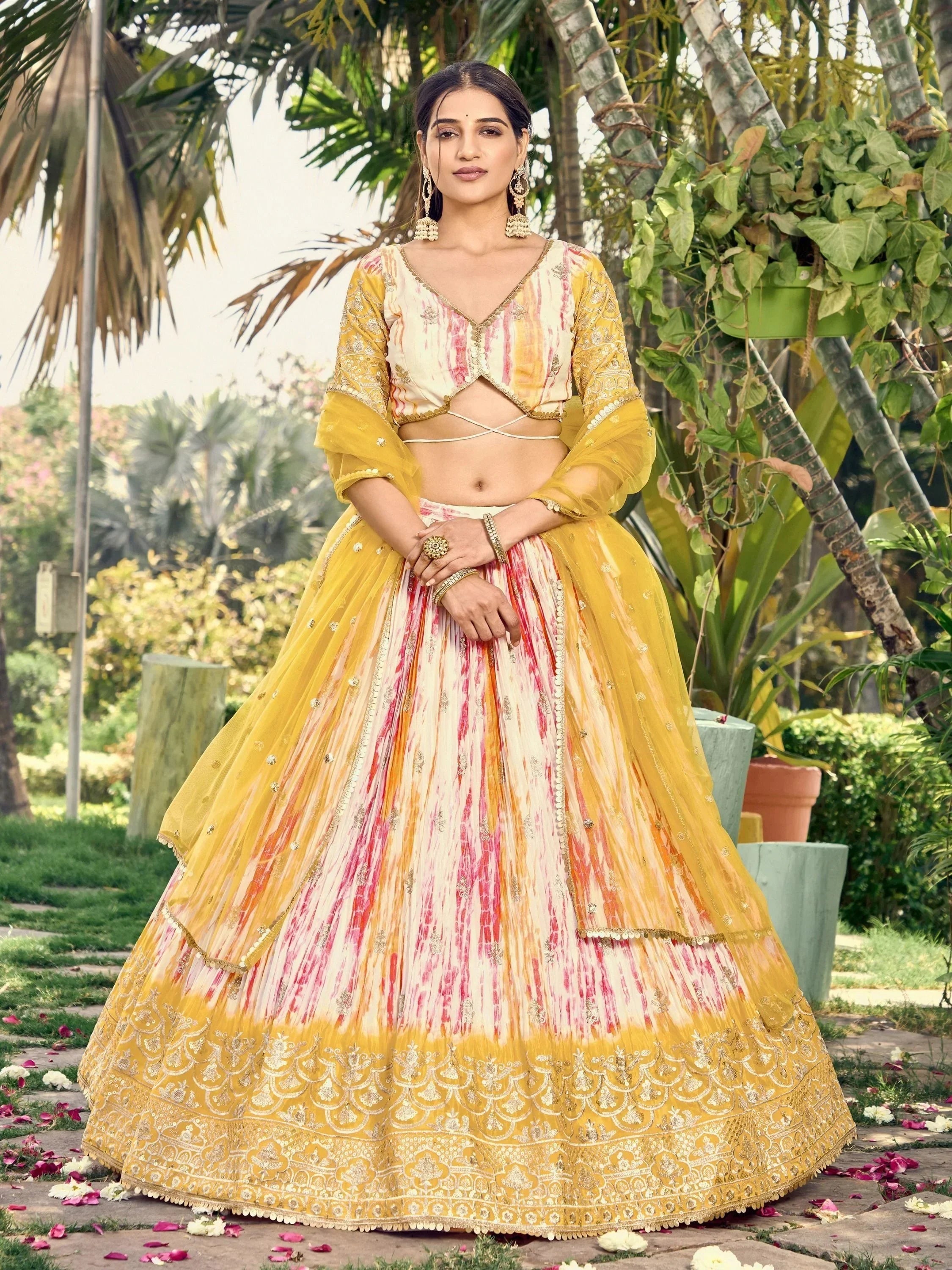 Yellow and pink tie-dye lehenga choli with gold embroidery, perfect for Indian ethnic wear events