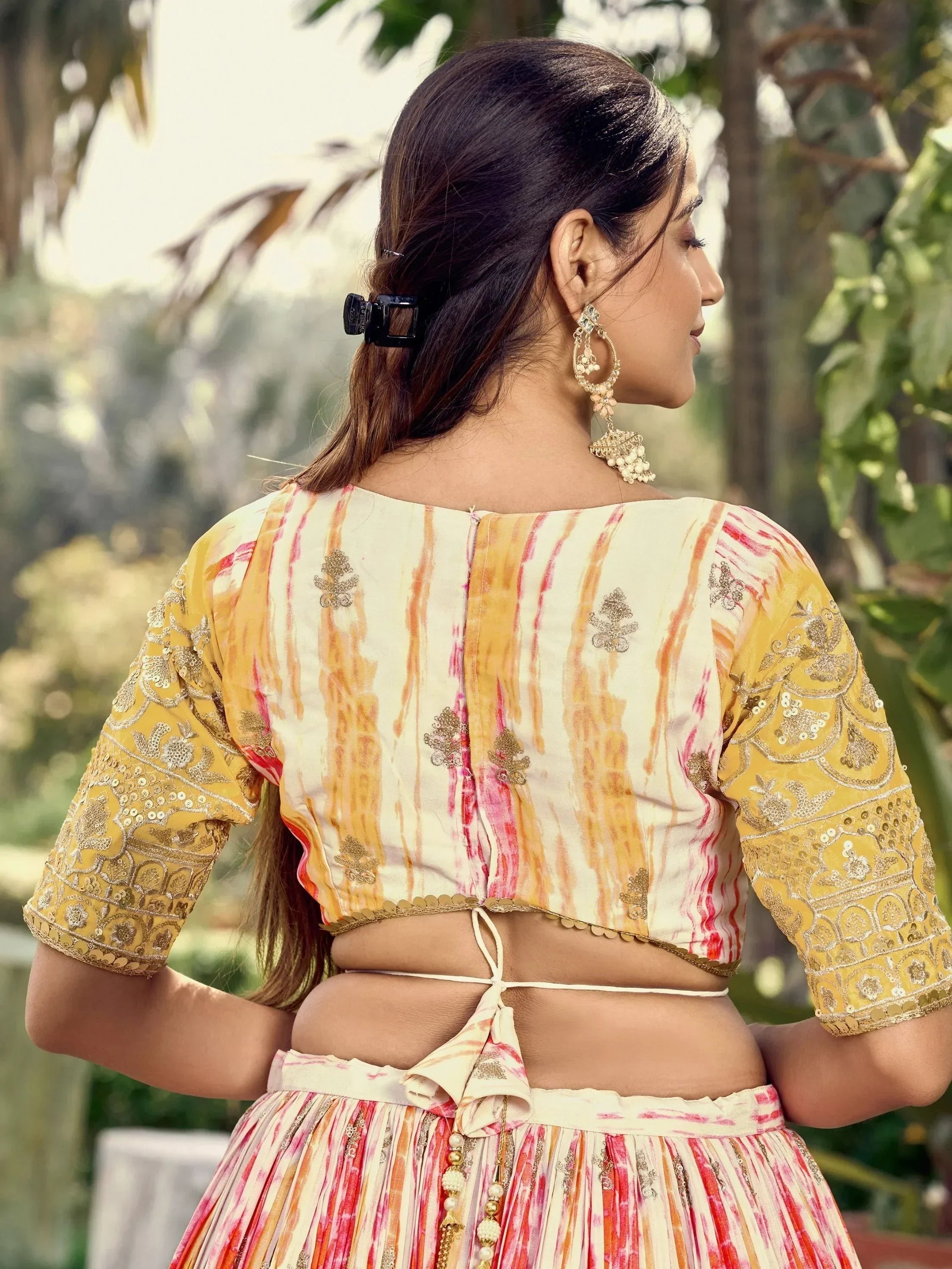 Yellow and pink tie-dye lehenga choli with gold embroidery, back view, ethnic wear for women