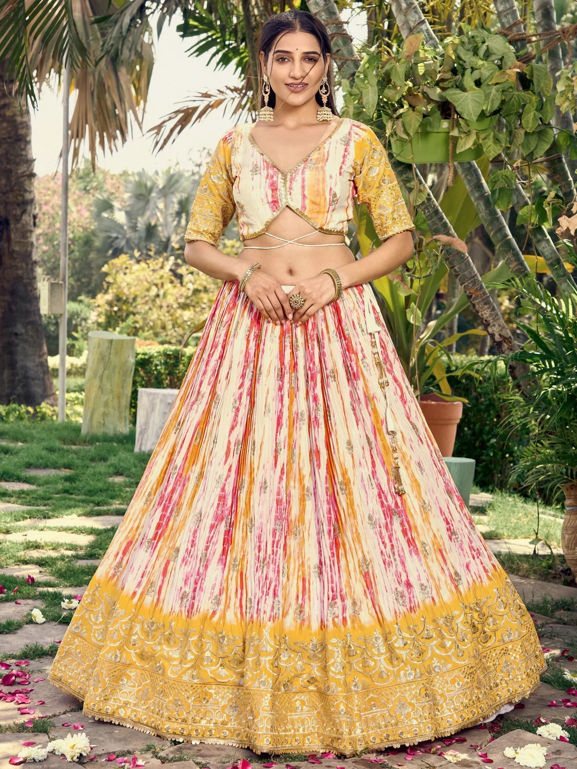 Yellow and pink tie-dye lehenga choli with gold embroidery, perfect for Indian ethnic wear