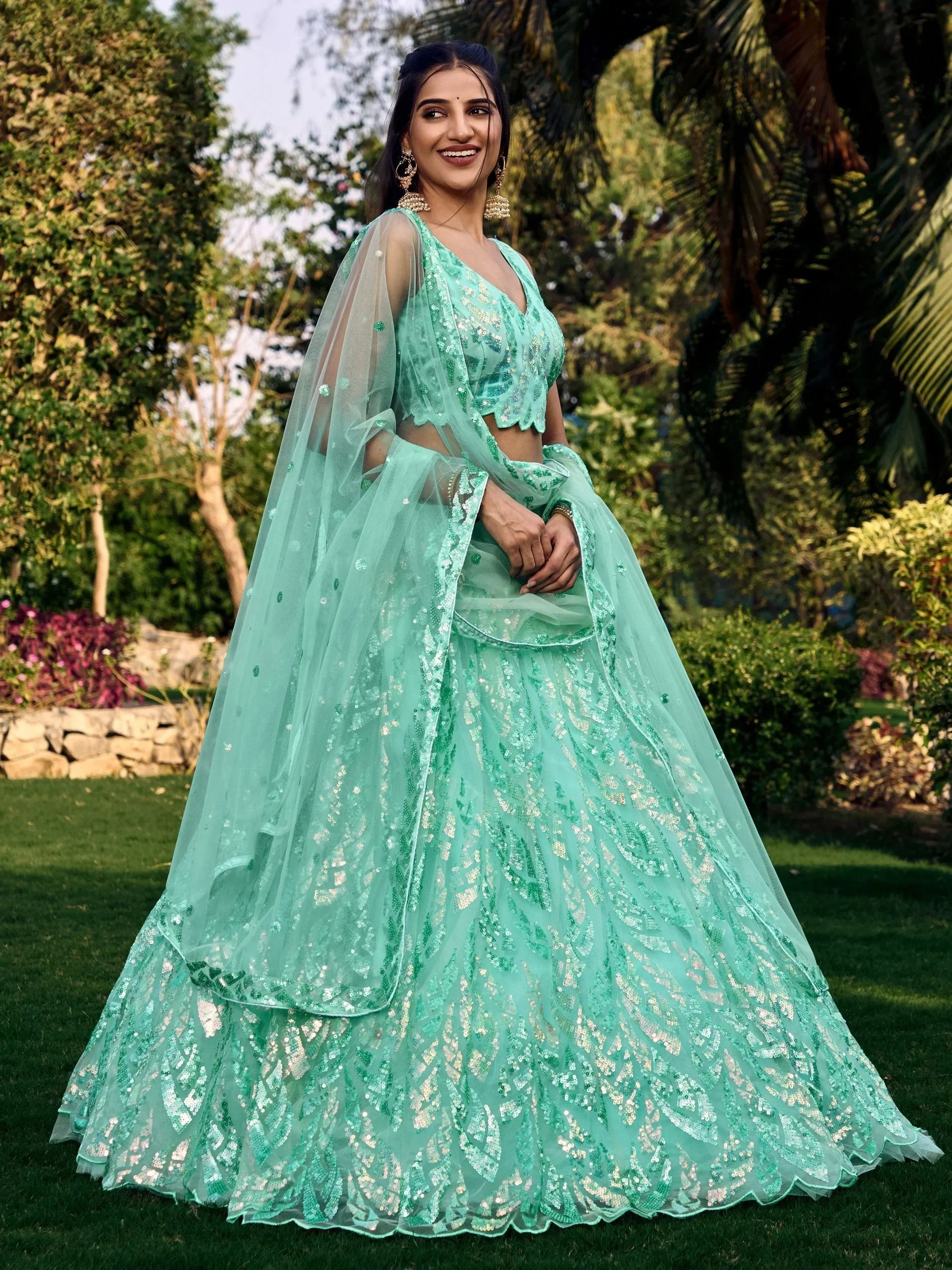 Mint green sequin lehenga choli with sheer dupatta, perfect for Indian weddings and festive occasions.