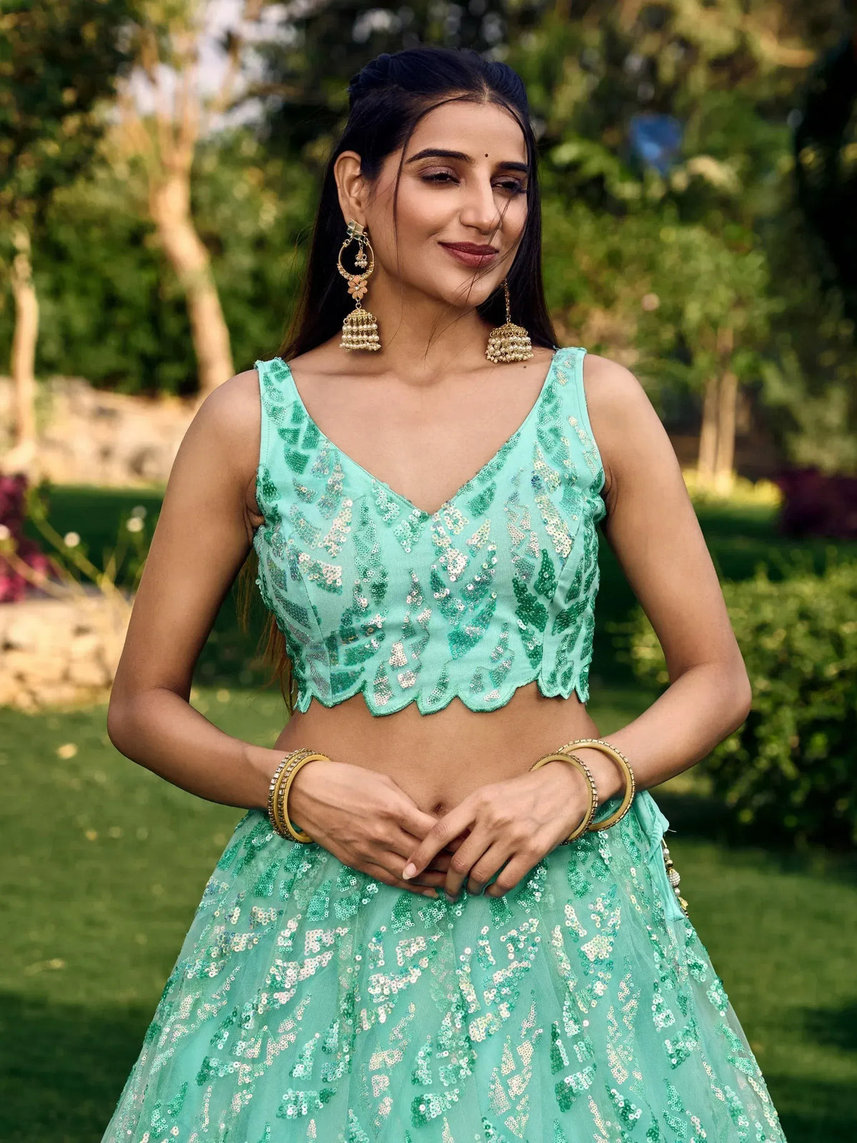 Mint green sequin lehenga choli with scalloped blouse, perfect for Indian ethnic wear and festive occasions.